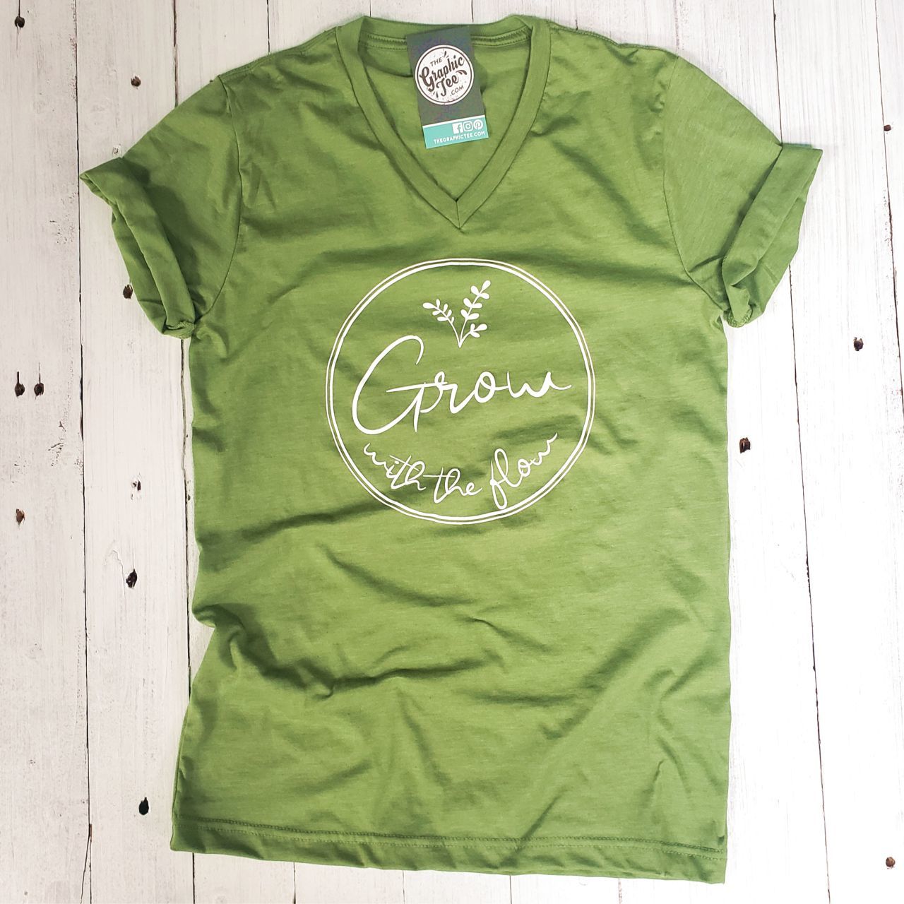 Unisex V-neck graphic tee from The Graphic Tee featuring a stylish "Grow with the Flow" design on soft fabric.