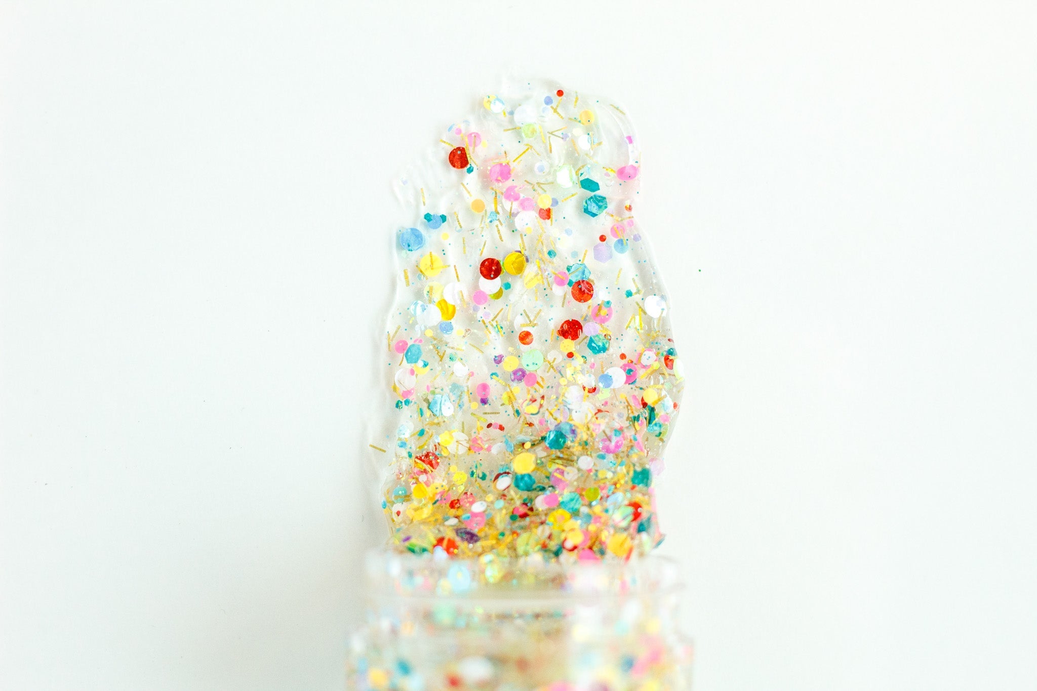 Colorful headband with rainbow-themed hair glitter from Gussy Up Bow Co., featuring vibrant, sparkling accents for festive style.