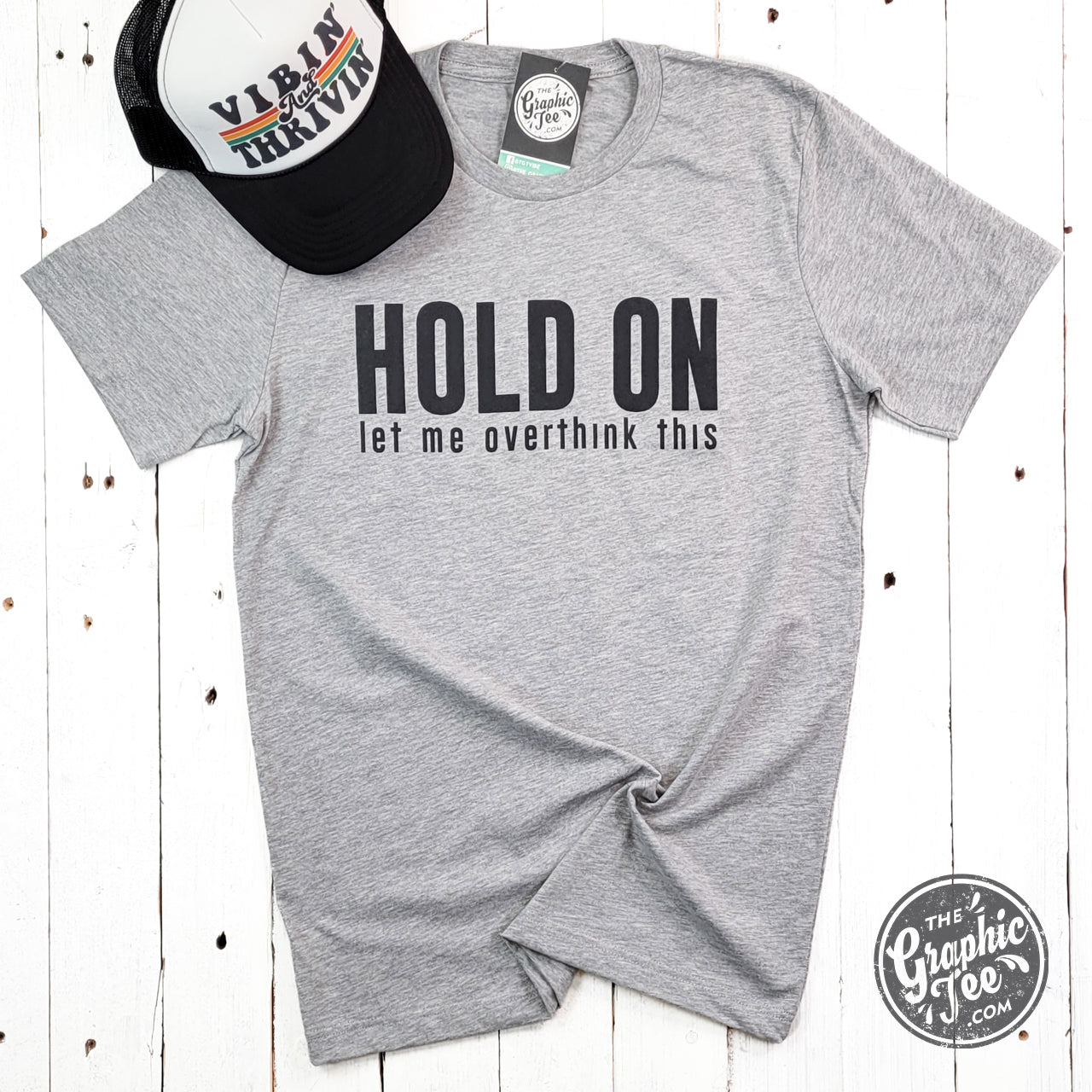 Unisex graphic T-shirt with "Hold On Let Me Overthink This" text, casual style by The Graphic Tee, shown on a plain background.