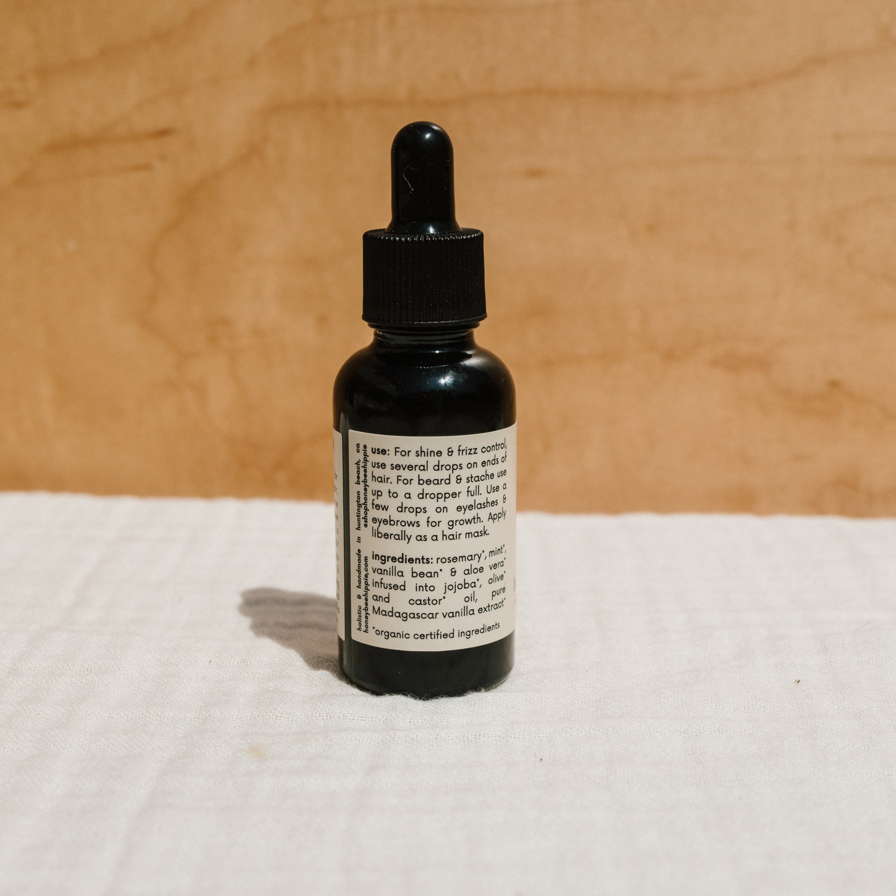 Bottle of Honeybee Hippie hair and beard oil, natural hair oil for nourishing and softening hair and facial hair.