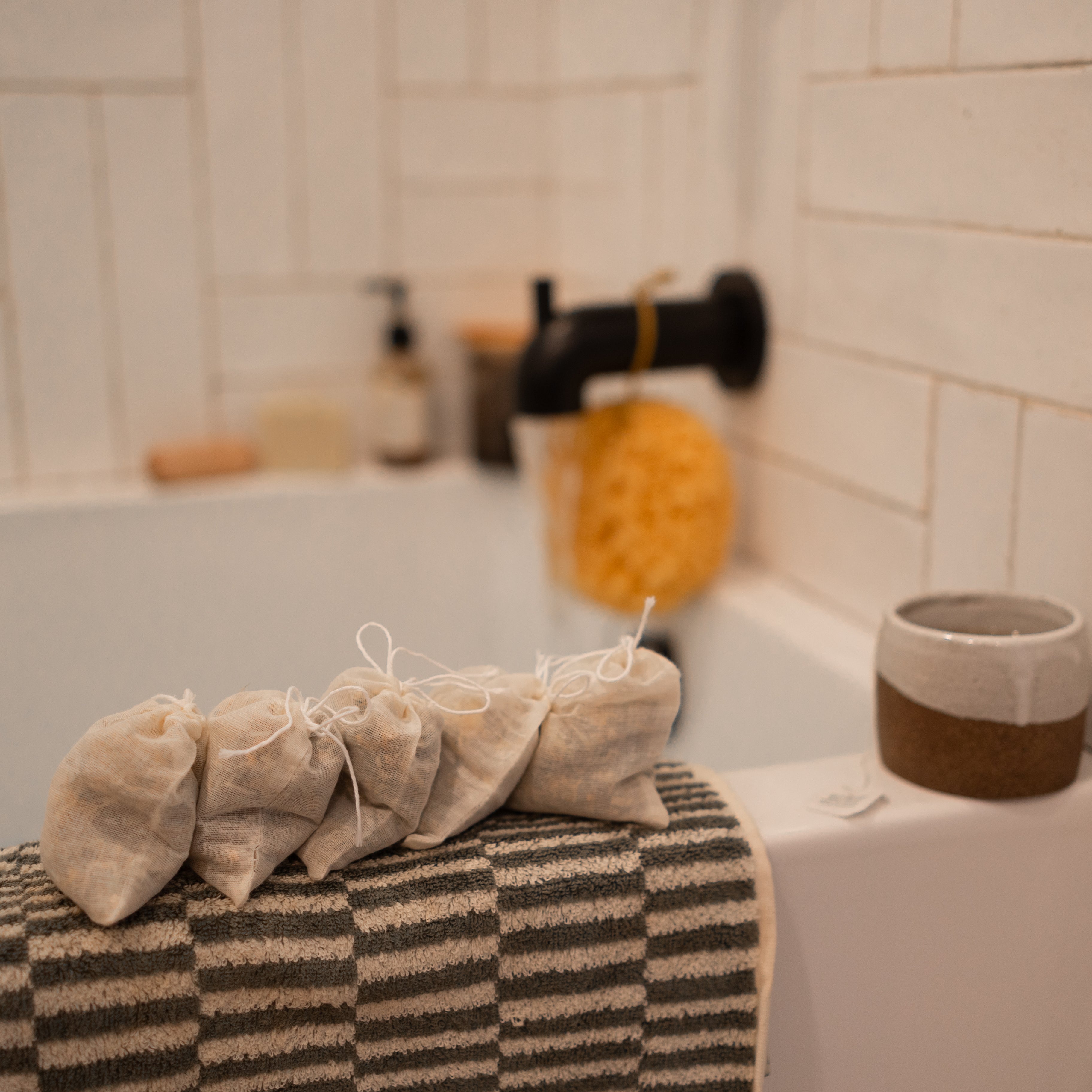 Postpartum herbal sitz bath by Honeybee Hippie, with dried herbs in a glass bowl for soothing postpartum care.
