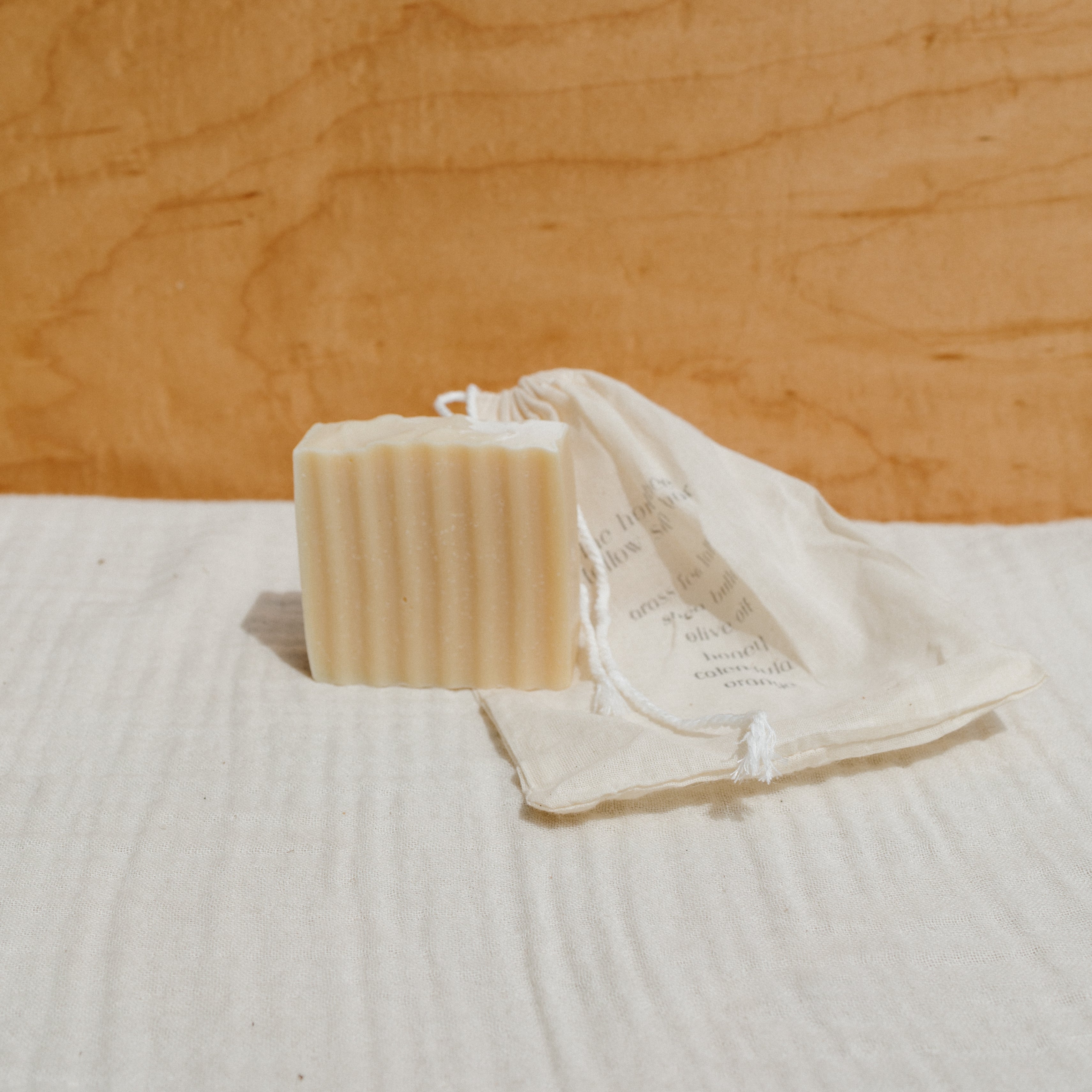 Honeybee Hippie tallow soap bar with natural ingredients, showcasing a rustic soap with a smooth surface and honeybee branding.