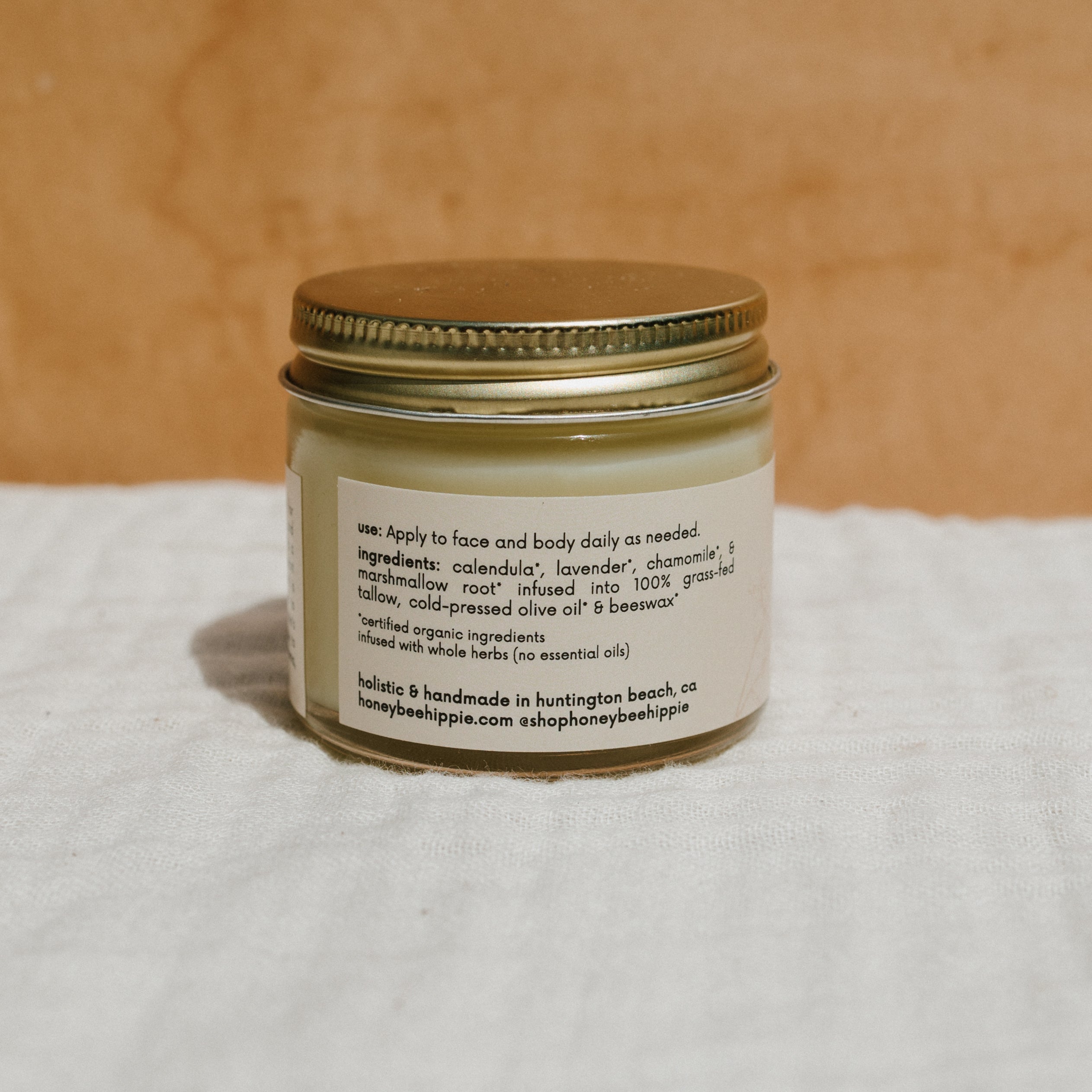 Natural Mama Tallow Butter in Honeybee Hippie Tallow Whip container, showcasing creamy, handcrafted skincare product.