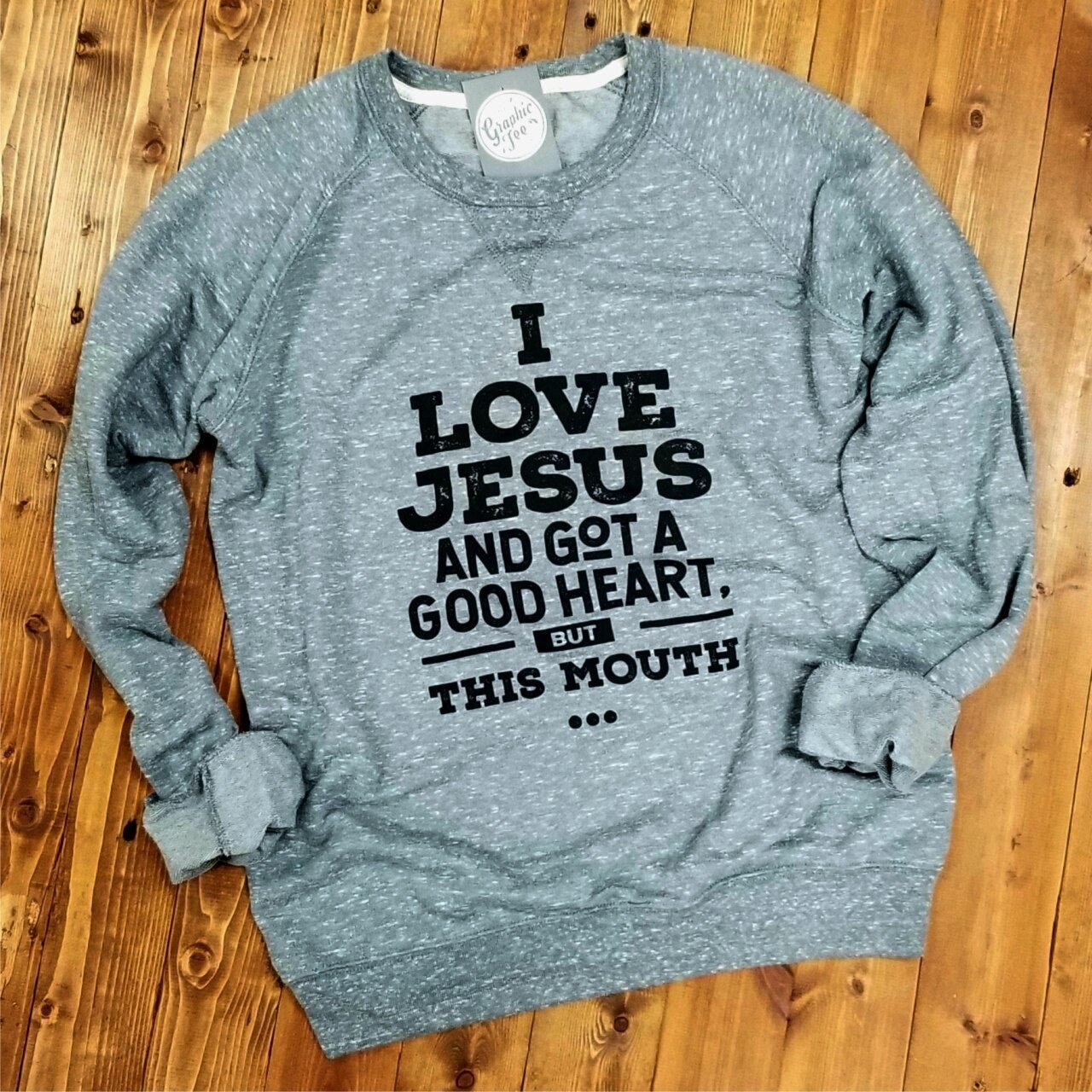 I Love Jesus and Got a Good Heart, but This Mouth crewneck sweatshirt by The Graphic Tee, featuring a bold graphic design.