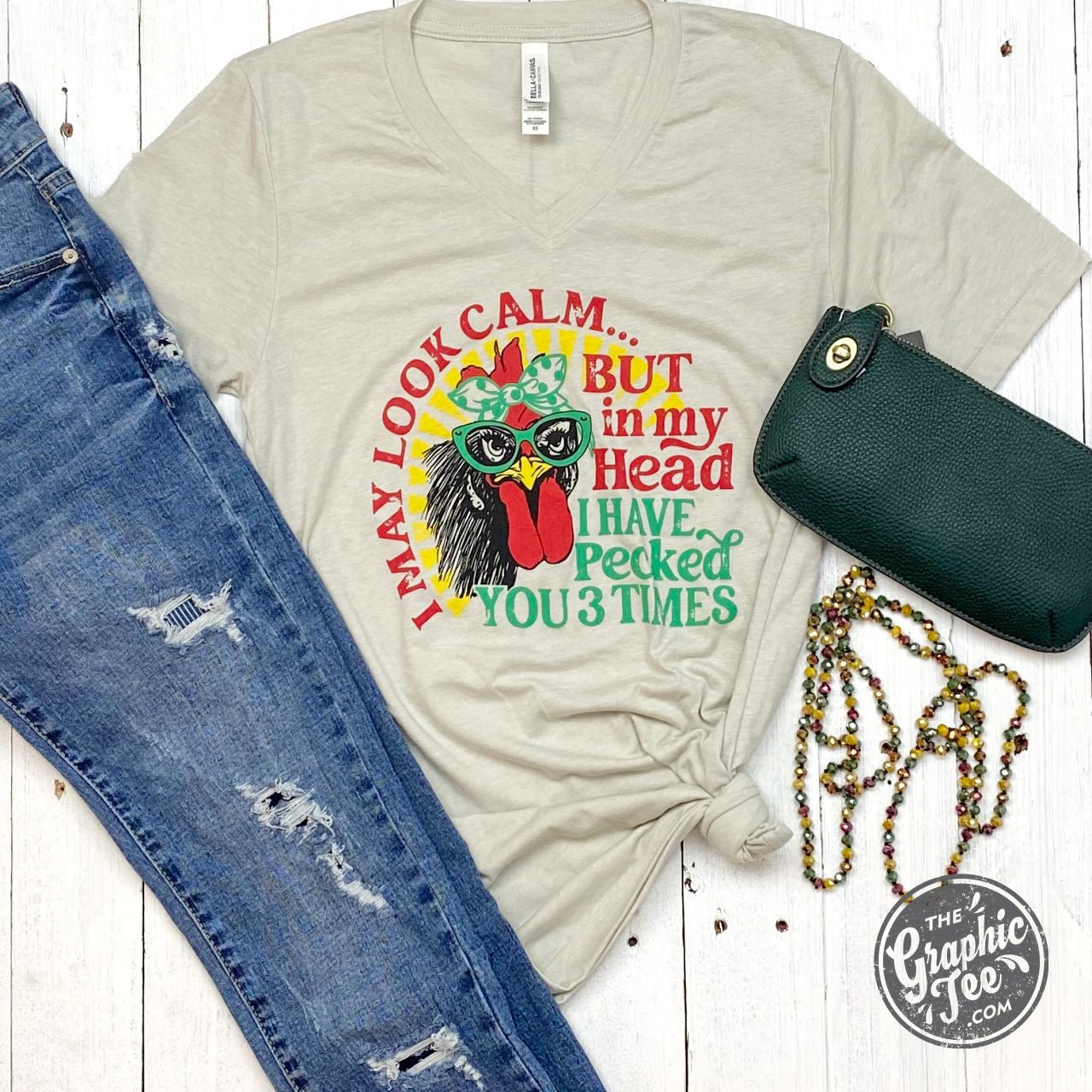 Black V-neck graphic T-shirt from The Graphic Tee with the phrase "I May Look Calm but..." printed on the front.