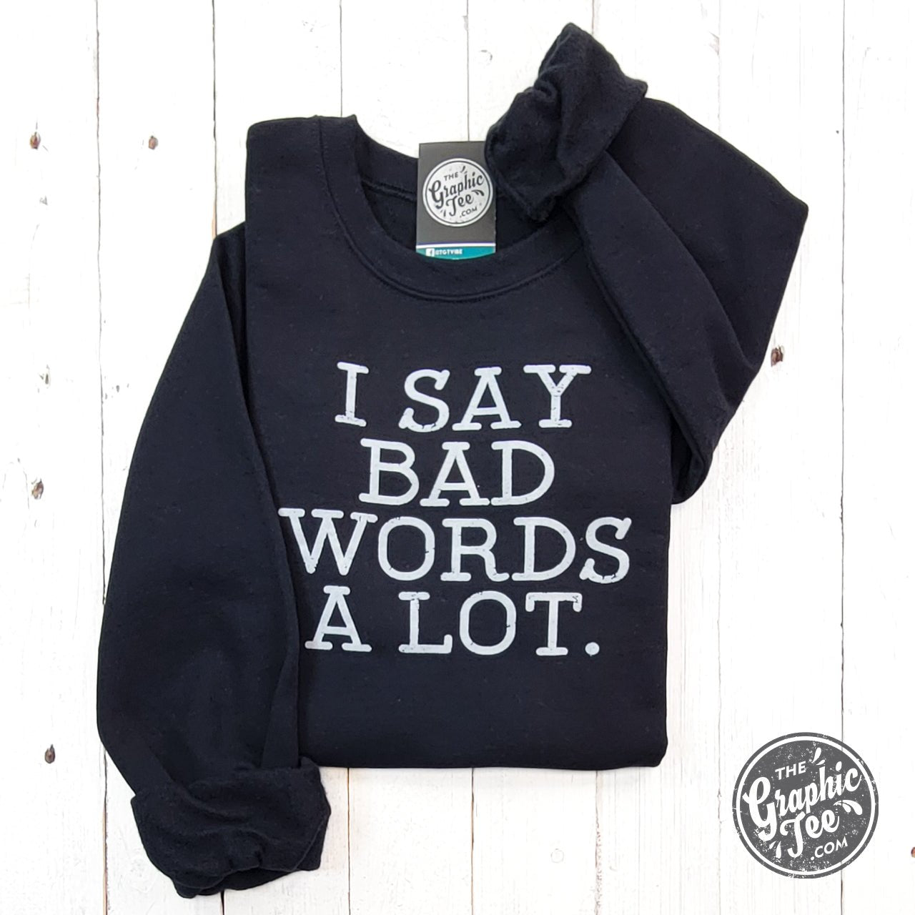 Black adult crewneck sweatshirt with "I Say Bad Words A Lot" graphic, from The Graphic Tee, casual and comfortable.