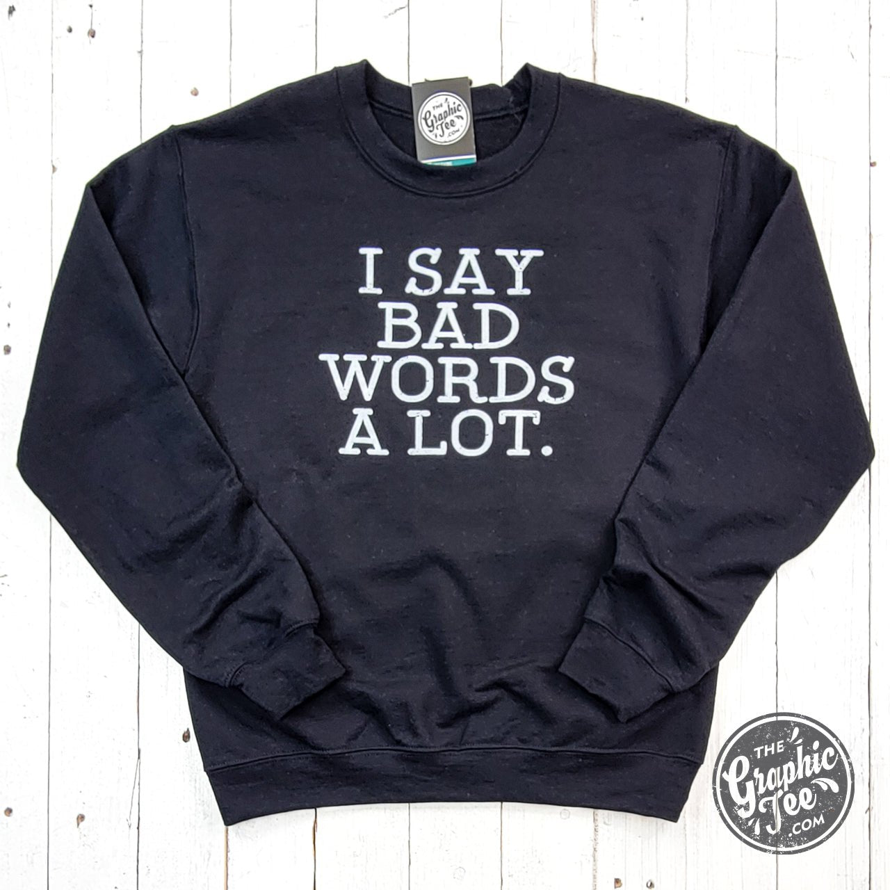 Black adult crewneck sweatshirt by The Graphic Tee featuring bold "I Say Bad Words A Lot" graphic design.