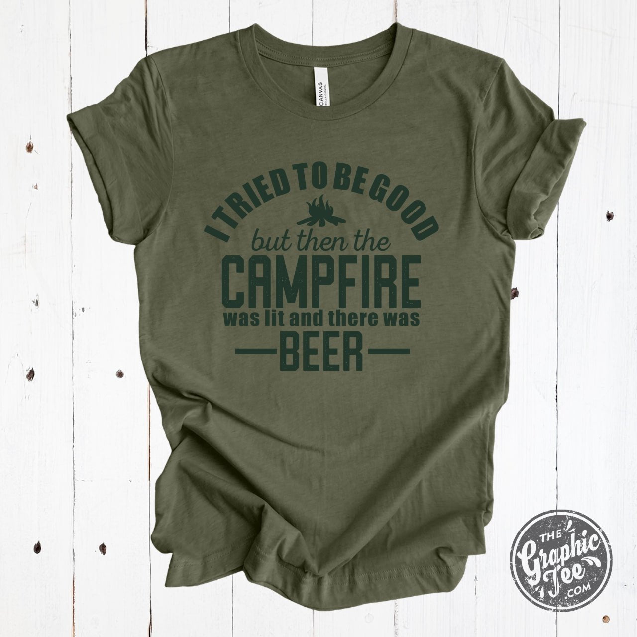 Heather military green short sleeve graphic t-shirt by The Graphic Tee with humorous "I Tried to Be Good" campfire and beer design.