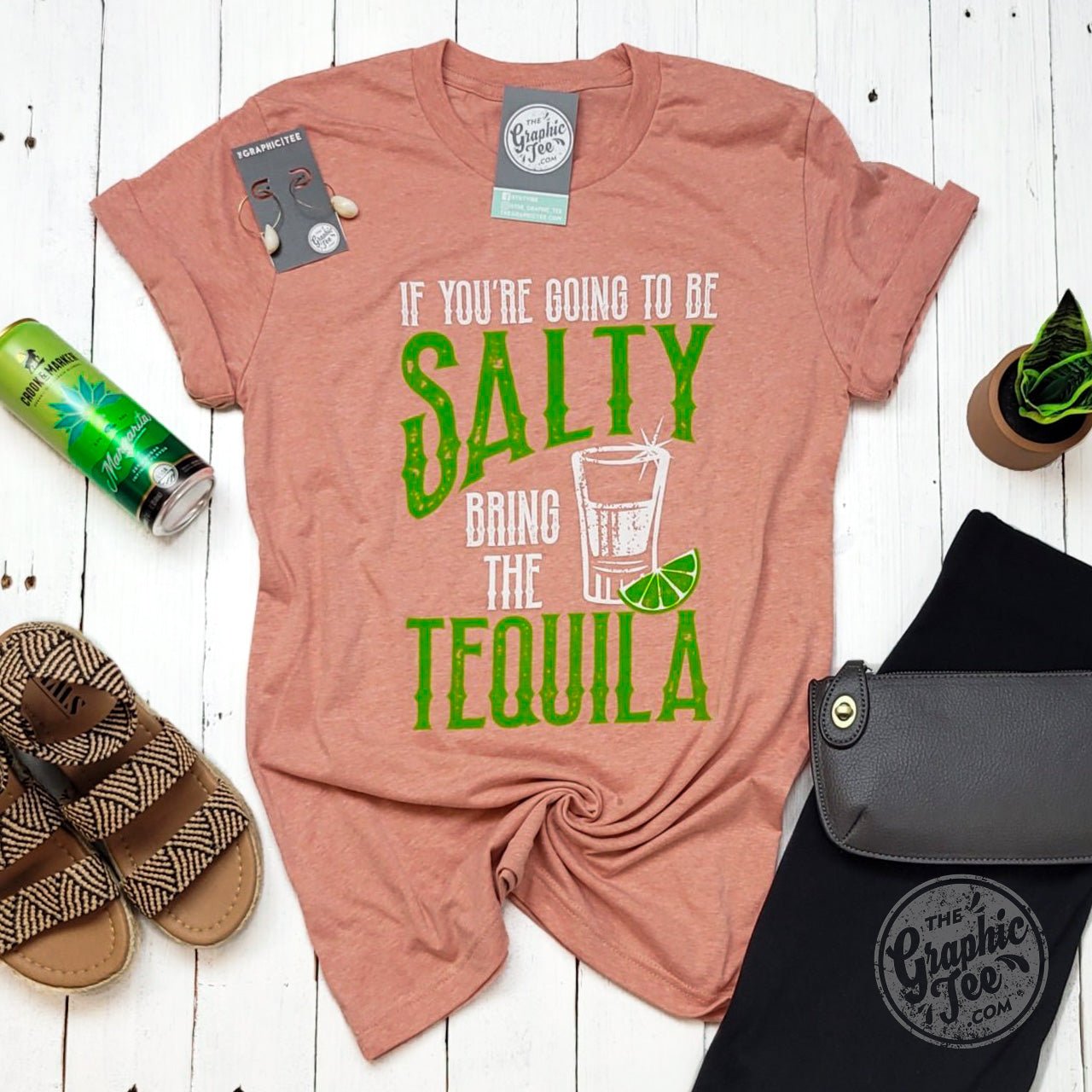 Short sleeve graphic tee by The Graphic Tee featuring the humorous "If You're Going To Be Salty Bring The Tequila" slogan on a crew neck design.