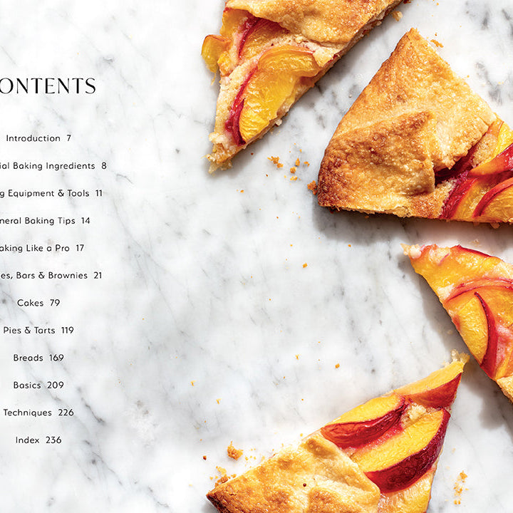 Hardcover baking book titled "Baking Favorites" by Insight Editions, featuring a cozy kitchen scene with baked goods.