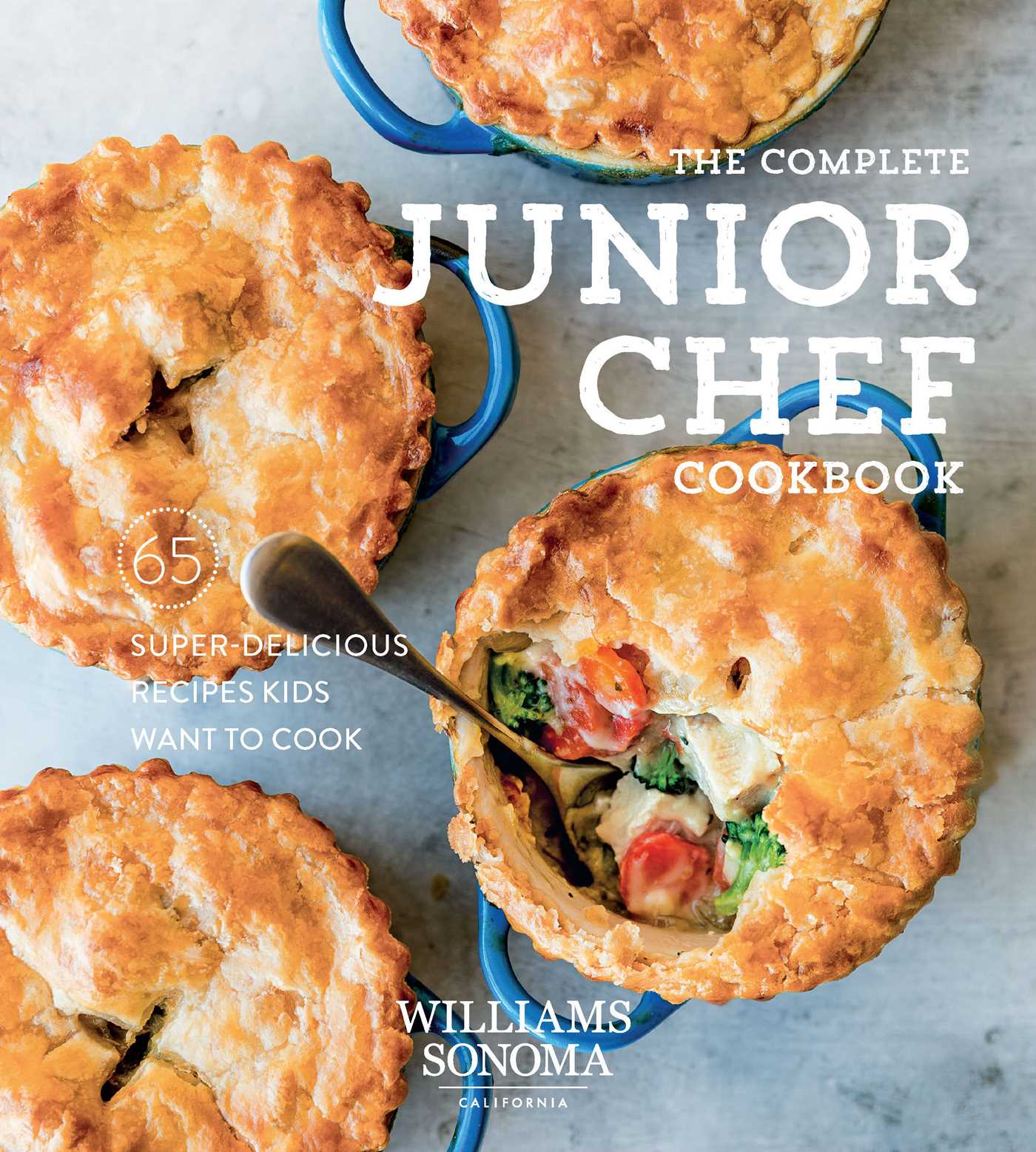 Hardcover Complete Junior Chef Cookbook by Insight Editions showing colorful recipes and cooking tips for kids.