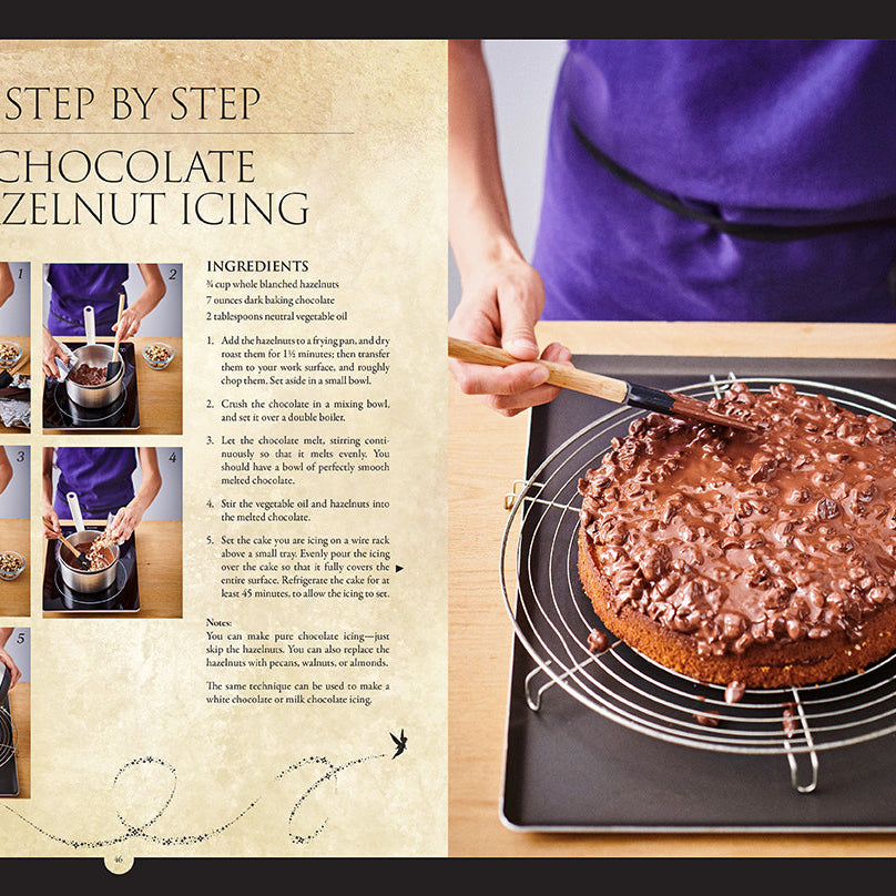 Hardcover Disney Enchanted Baking cookbook by Insight Editions showing a colorful dessert spread with whimsical baking decorations.