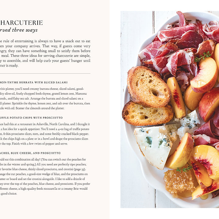 Hardcover book titled "Entertaining with Charm" by Insight Editions featuring elegant design and decorative interior pages.