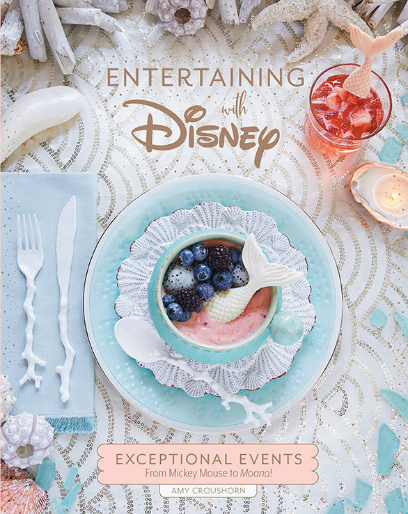 Hardcover book titled "Entertaining with Disney" by Insight Editions featuring Disney-themed party ideas and decorations.