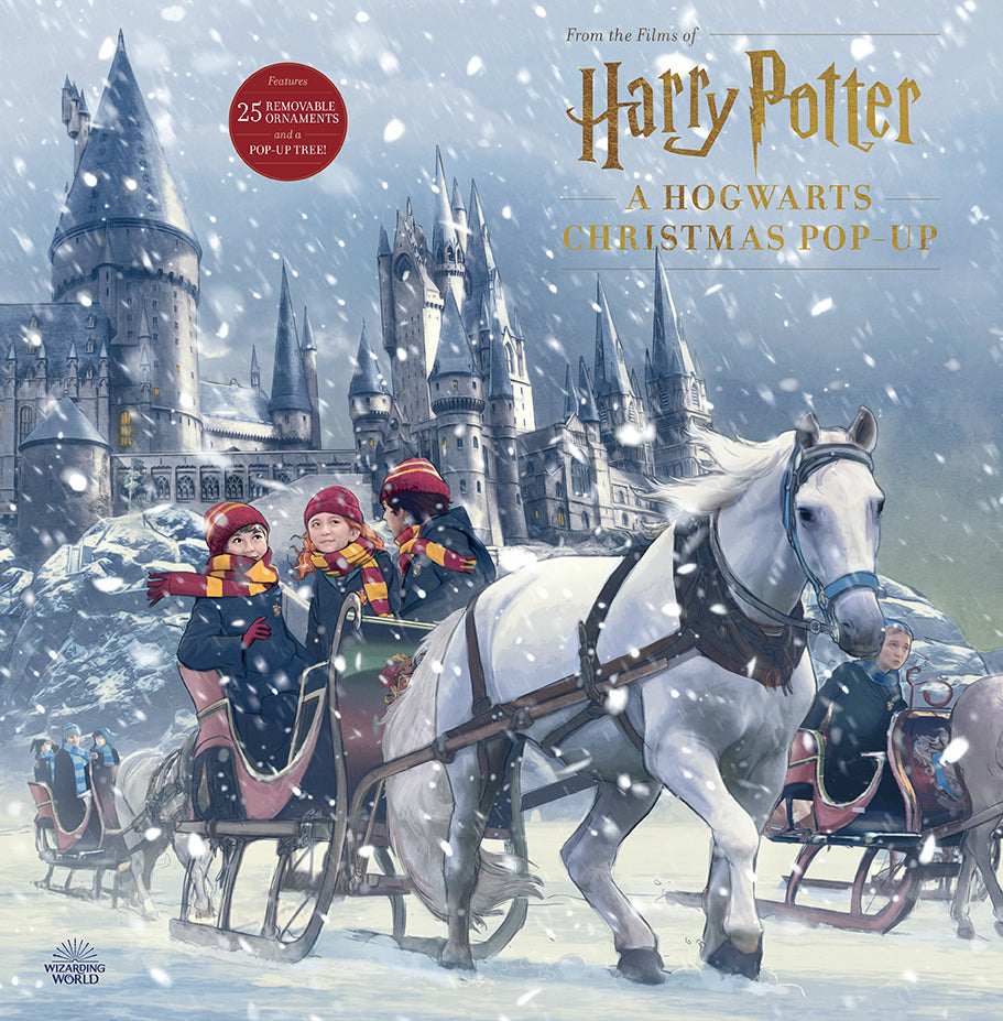 Hardcover Harry Potter: A Hogwarts Christmas Pop-Up book by Insight Editions with detailed magical Hogwarts scene inside.