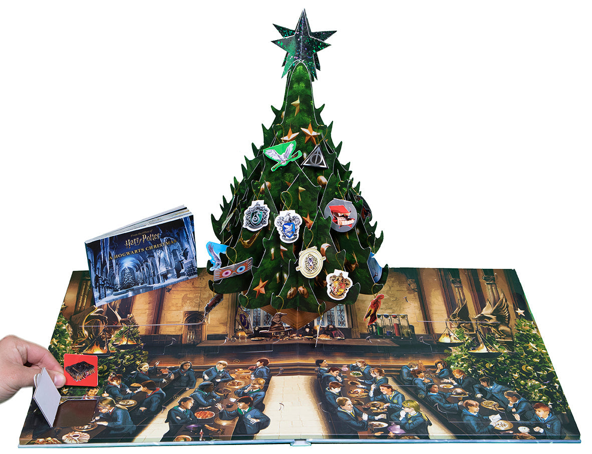 Hardcover Harry Potter: A Hogwarts Christmas Pop-Up book by Insight Editions with detailed magical Christmas scenes and pop-up illustrations.