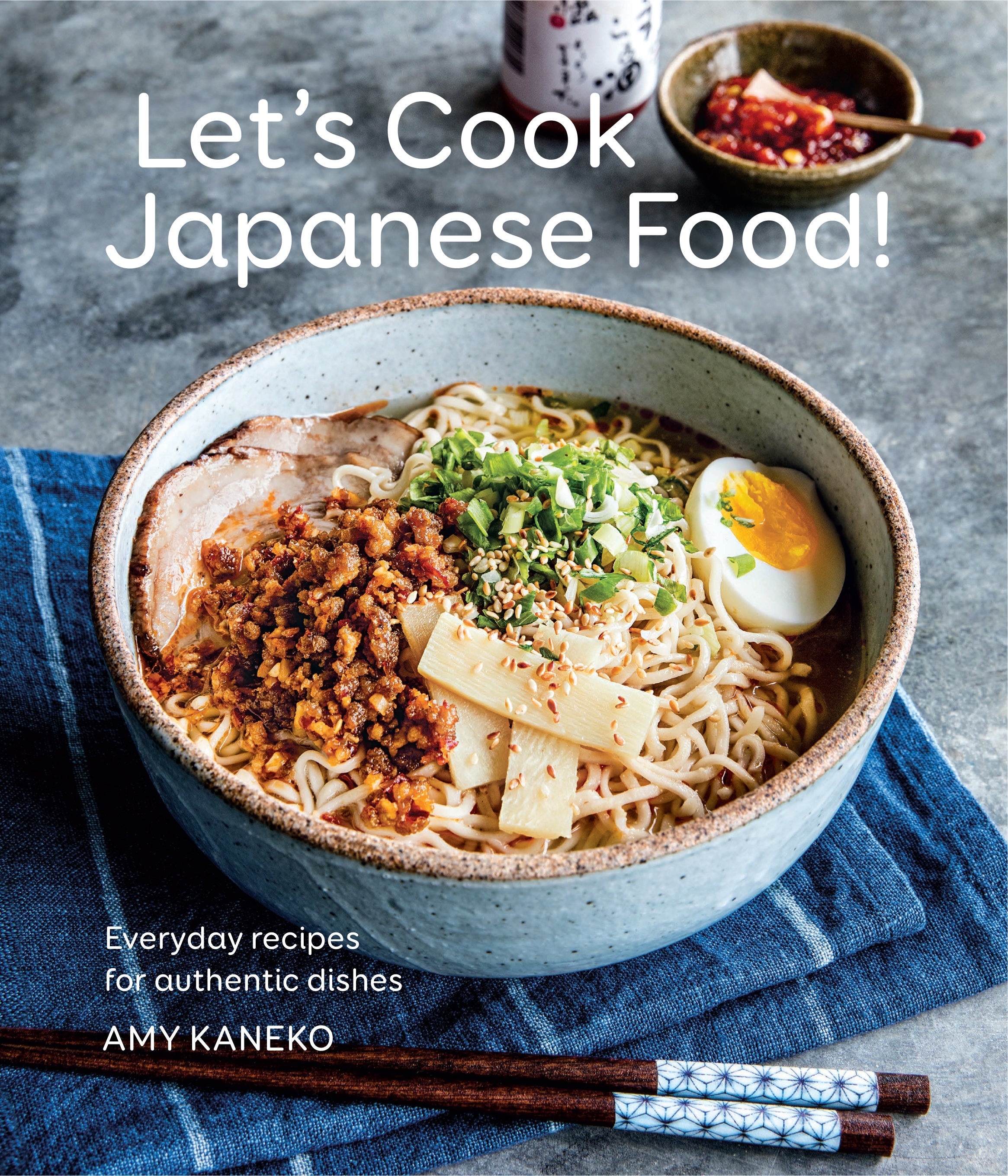Hardcover cookbook titled "Let's Cook Japanese Food!" by Insight Editions, featuring Japanese cuisine recipes and cooking techniques.