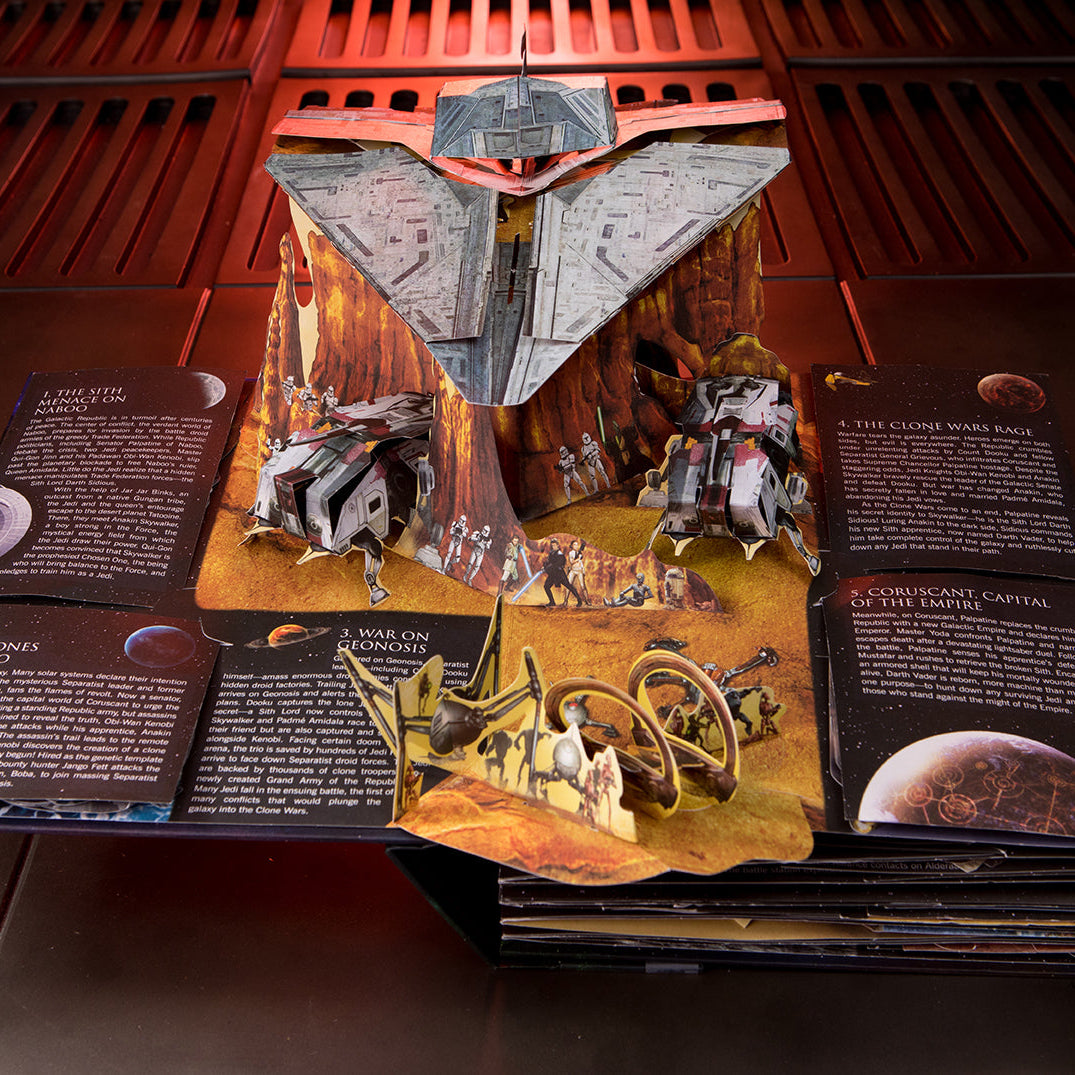 Hardcover of Star Wars: The Ultimate Pop-Up Galaxy by Insight Editions showing a vibrant, detailed pop-up galaxy scene inside the book.