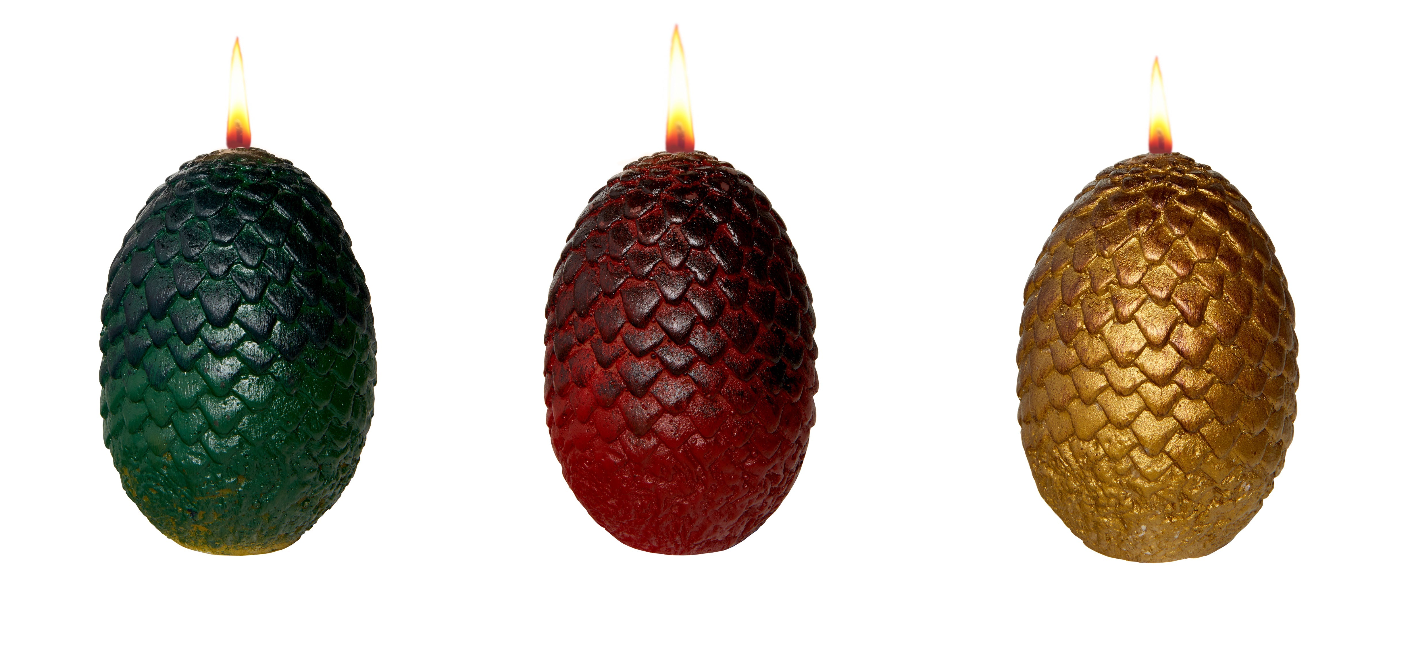 Set of three sculpted dragon egg candles from Game of Thrones by Insight Editions, featuring detailed textured surfaces and warm candlelight.