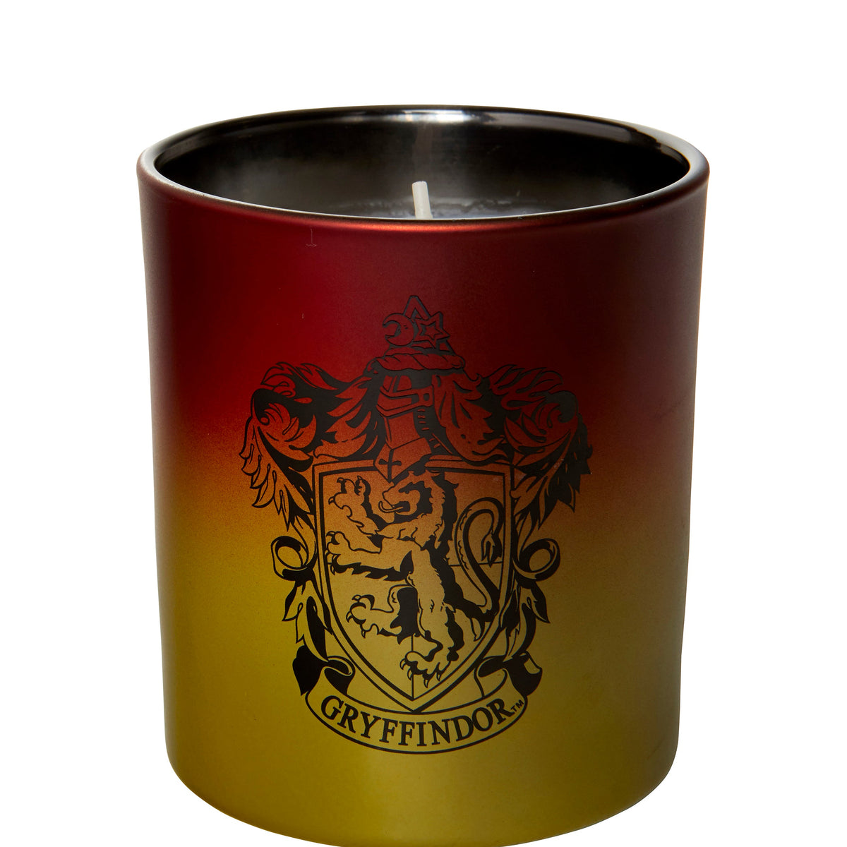 Gryffindor glass candle from Harry Potter home goods by Insight Editions, featuring a clear glass container with Gryffindor house symbols.