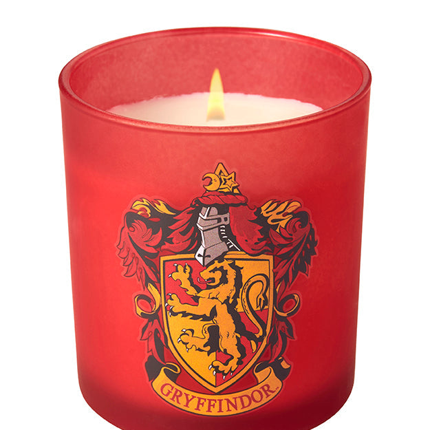 Gryffindor scented glass candle from Harry Potter home goods collection by Insight Editions, with a decorative Gryffindor crest design.