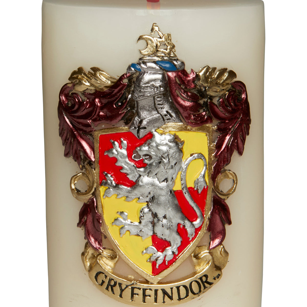 Gryffindor insignia sculpted candle from Harry Potter home goods, featuring detailed Gryffindor crest and red and gold design.