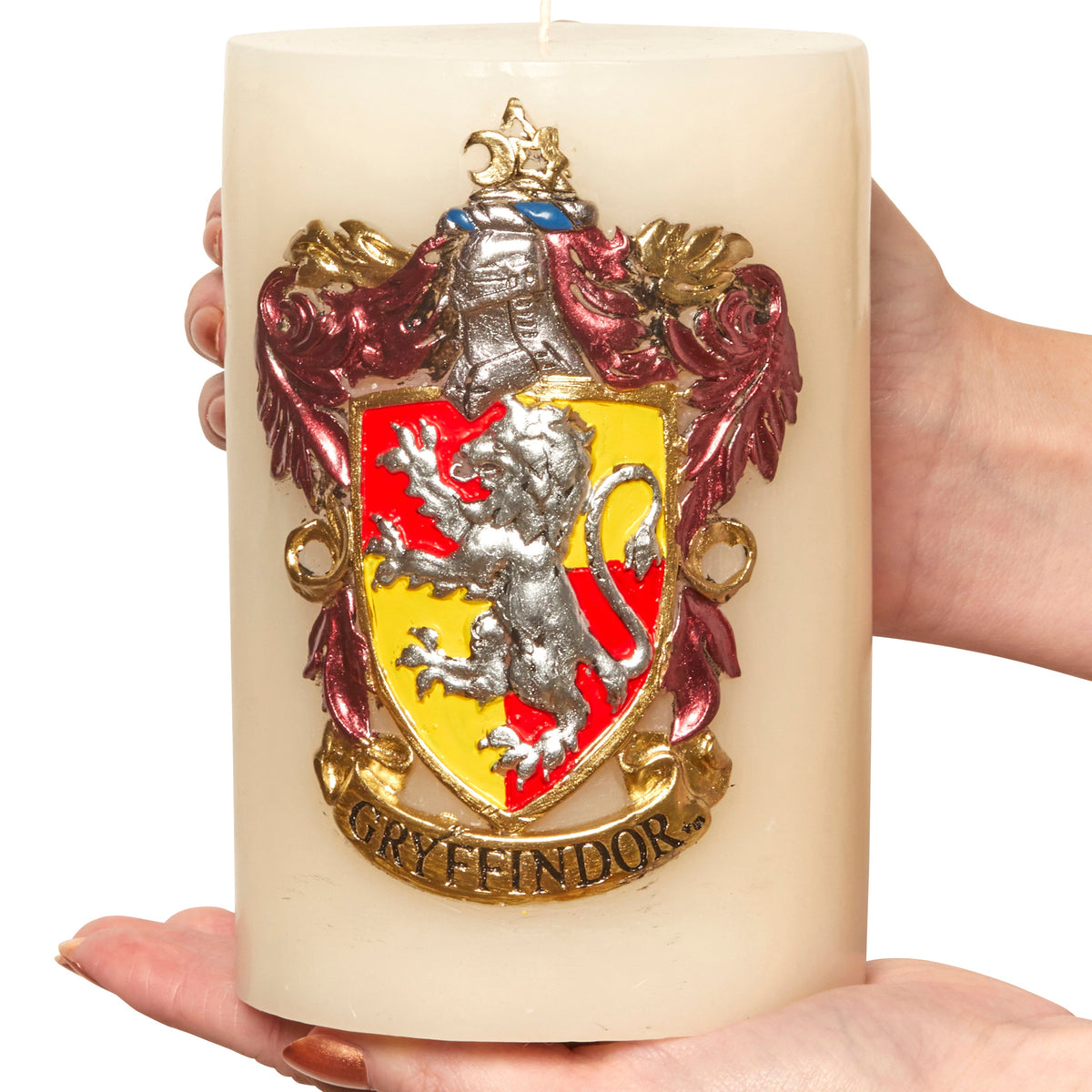 Gryffindor insignia candle from Harry Potter by Insight Editions, featuring a sculpted Hogwarts house crest on a decorative candle.