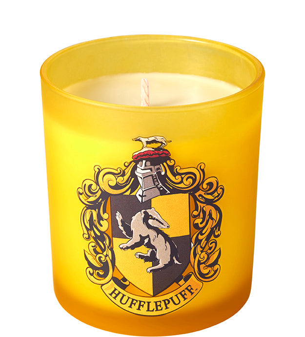 Hufflepuff scented glass candle from Harry Potter home goods collection featuring a decorative candle with Hufflepuff emblem.