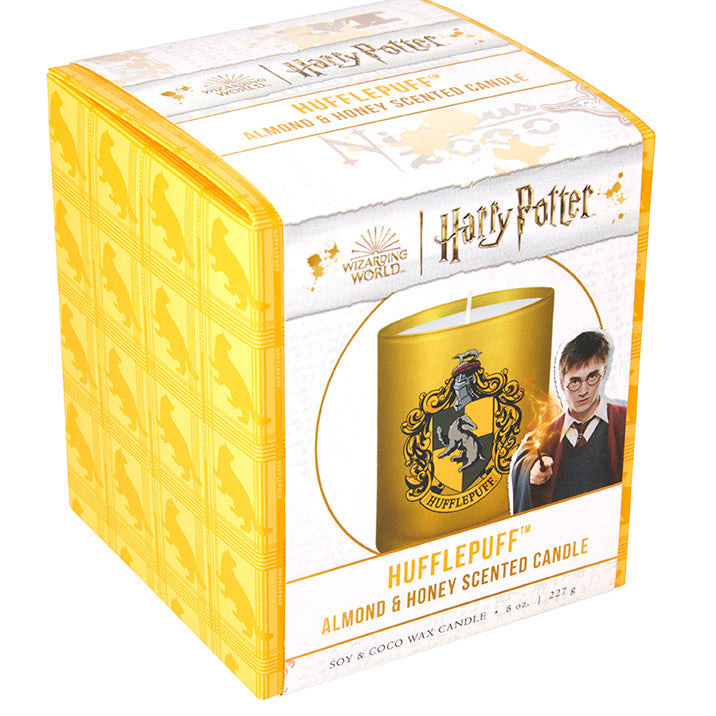 Hufflepuff scented glass candle from Harry Potter home goods by Insight Editions, featuring a transparent glass container with Hufflepuff branding.