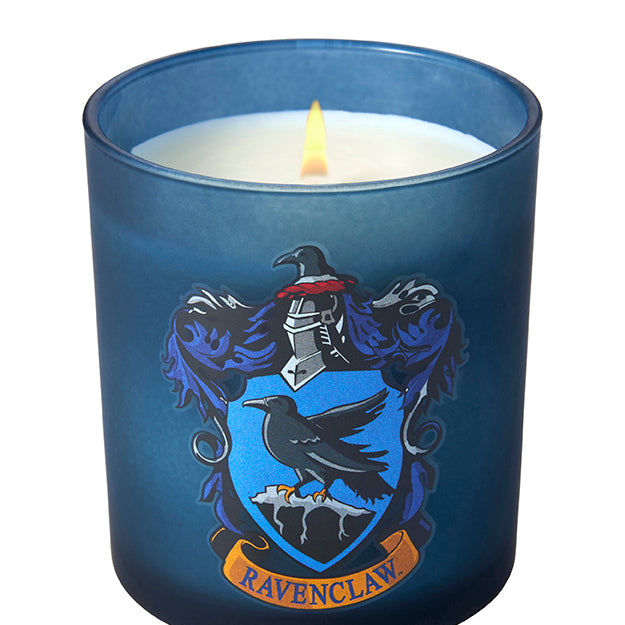 Ravenclaw scented glass candle from Harry Potter series by Insight Editions, featuring the Hogwarts house emblem and blue glass.