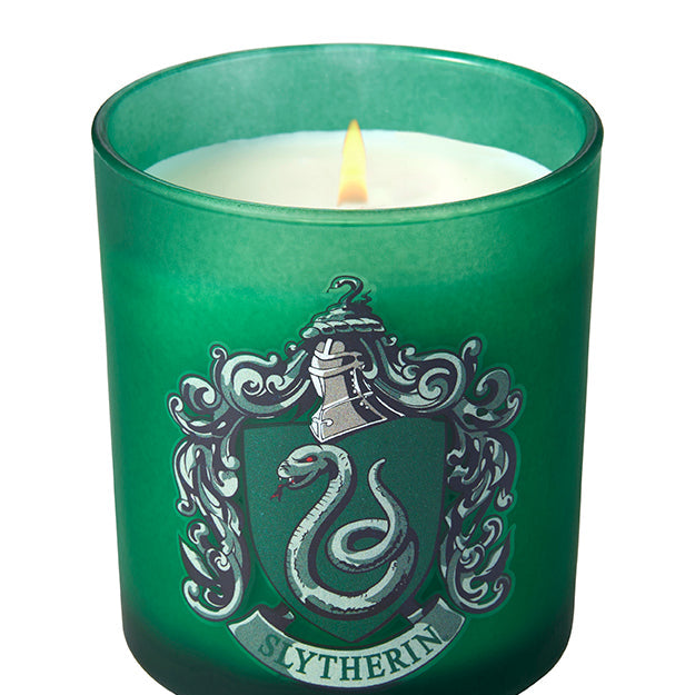 Slytherin scented glass candle from Harry Potter by Insight Editions, featuring green glass and Slytherin house emblem.