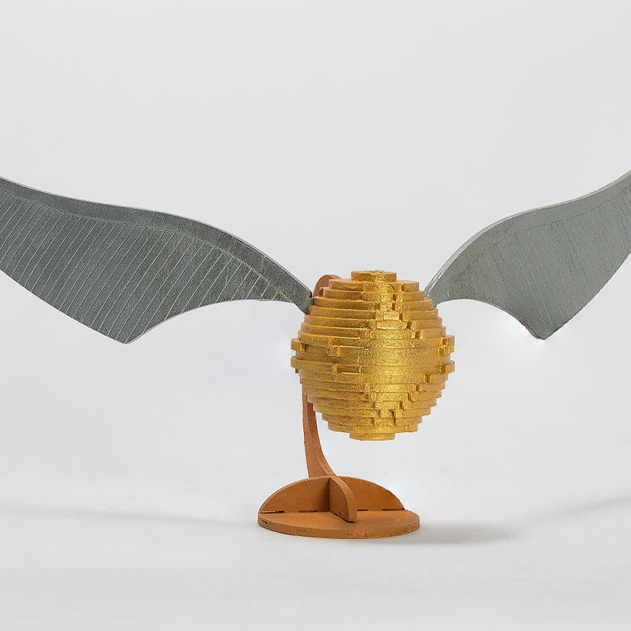 IncrediBuilds Harry Potter Golden Snitch 3D wood model and book kit by Insight Editions, featuring detailed Harry Potter-themed design.