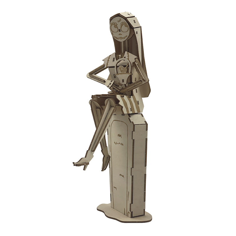 IncrediBuilds Nightmare Before Christmas Sally kit with a book and 3D wood model, featuring detailed Sally figure and packaging.
