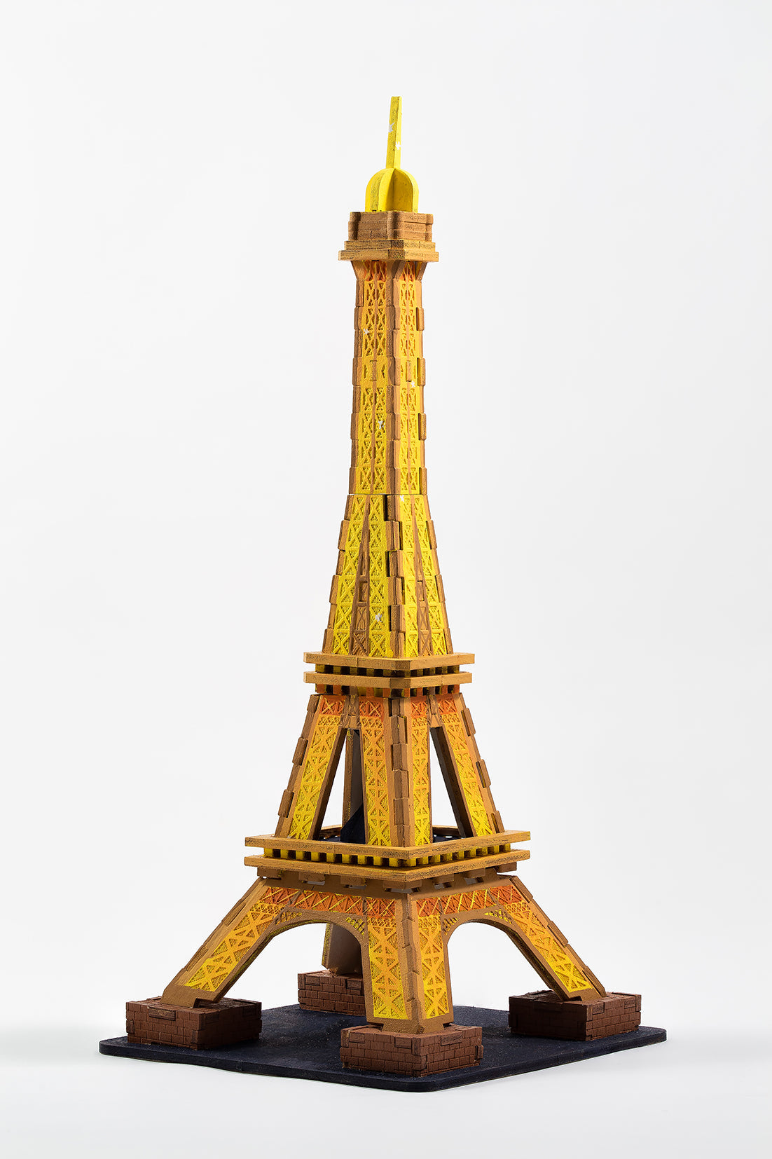 IncrediBuilds Paris Eiffel Tower kit featuring a book and 3D wood model, with detailed instructions and wooden pieces for assembly.