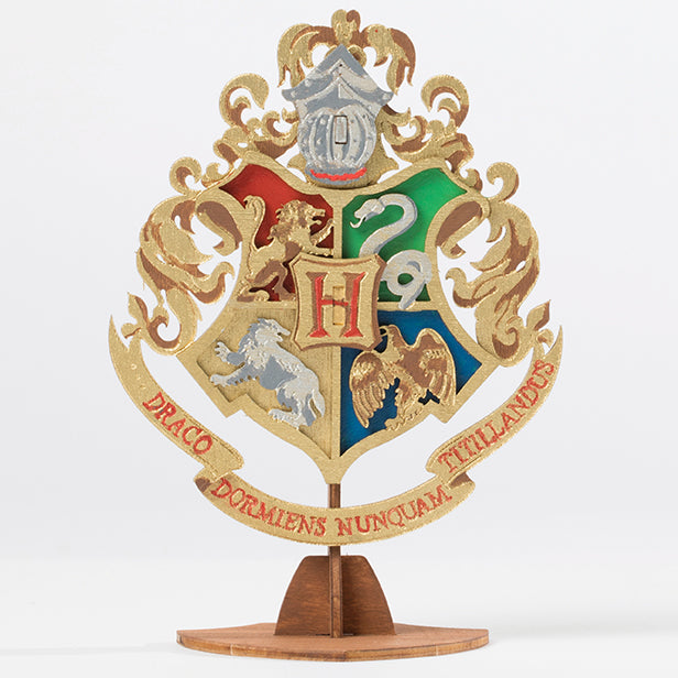 Softcover Harry Potter Hogwarts Crest book and 3D wood model by IncrediBuilds, featuring detailed craftsmanship and iconic design.