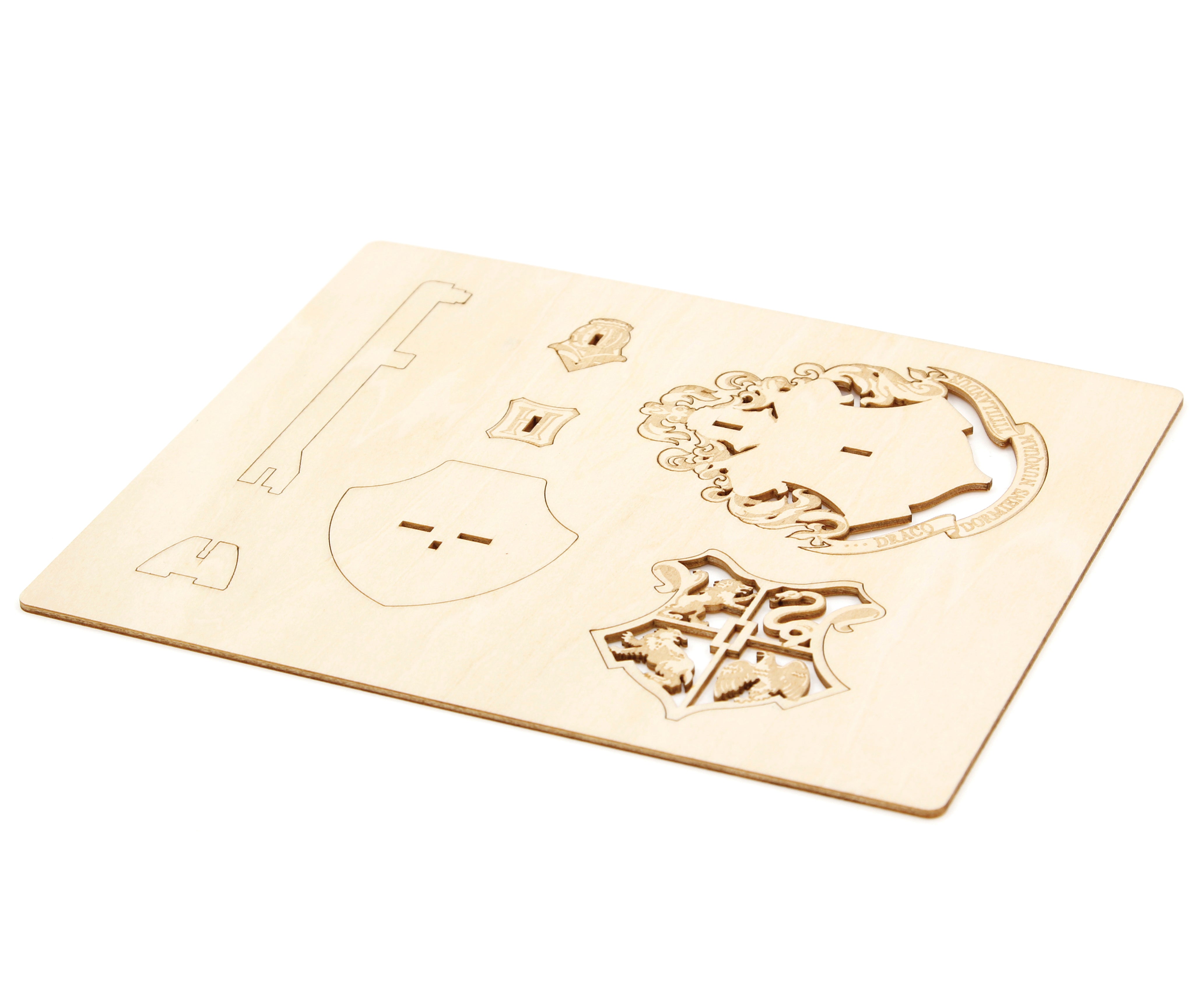 Softcover Harry Potter Hogwarts Crest book and 3D wood model by IncrediBuilds, featuring detailed crest design and packaging.