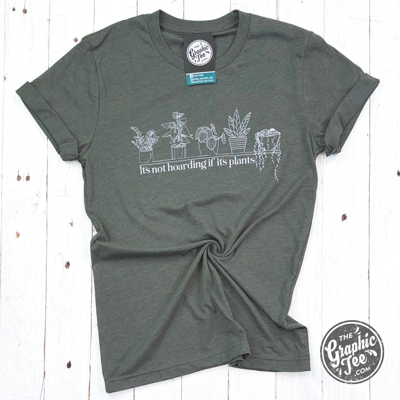 Heather military green short sleeve graphic tee by The Graphic Tee with plant-themed design reading "It's Not Hoarding if it's Plants".