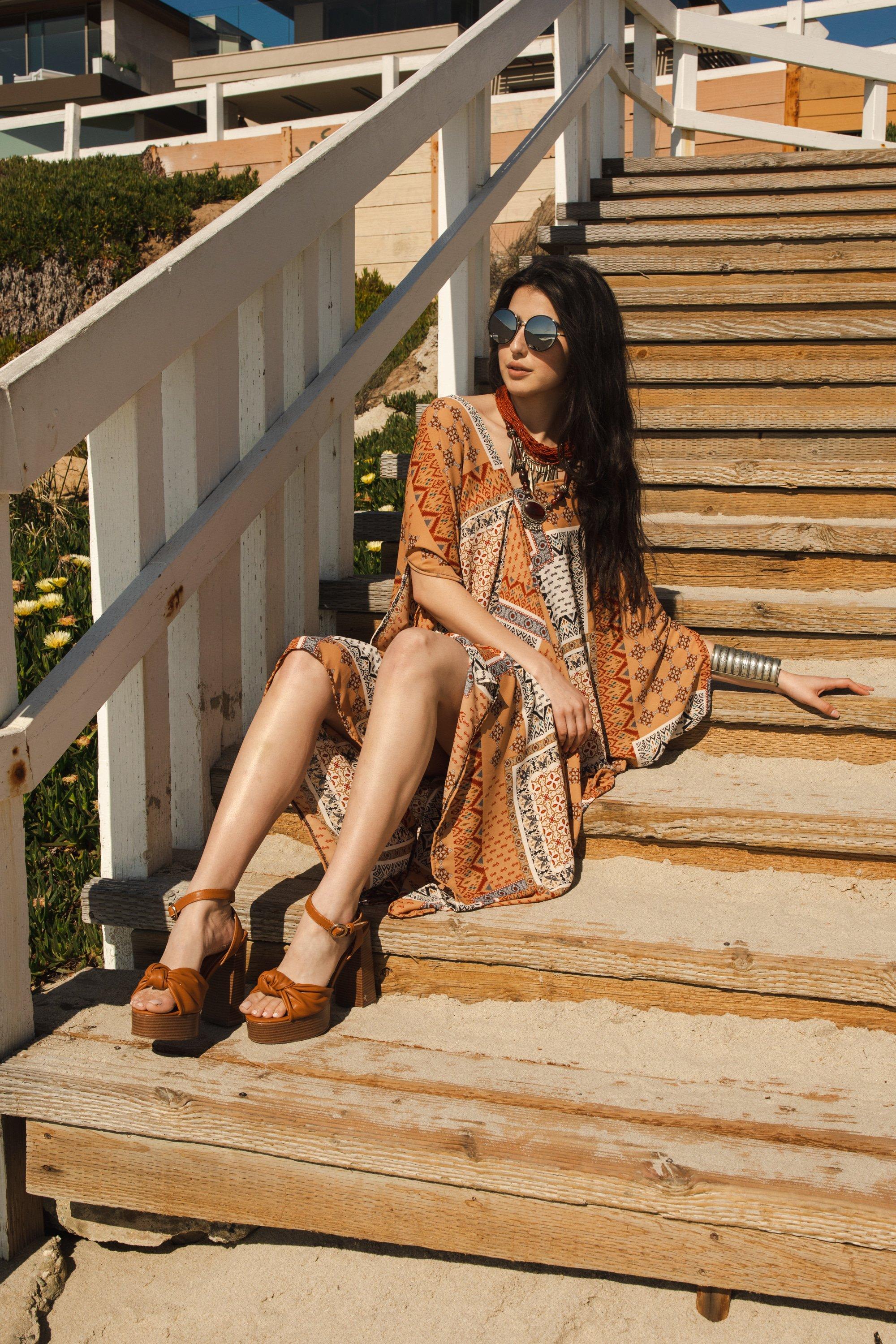 Handmade Hera Caftan by Jennafer Grace featuring flowing fabric and intricate detailing in a vibrant, elegant style.