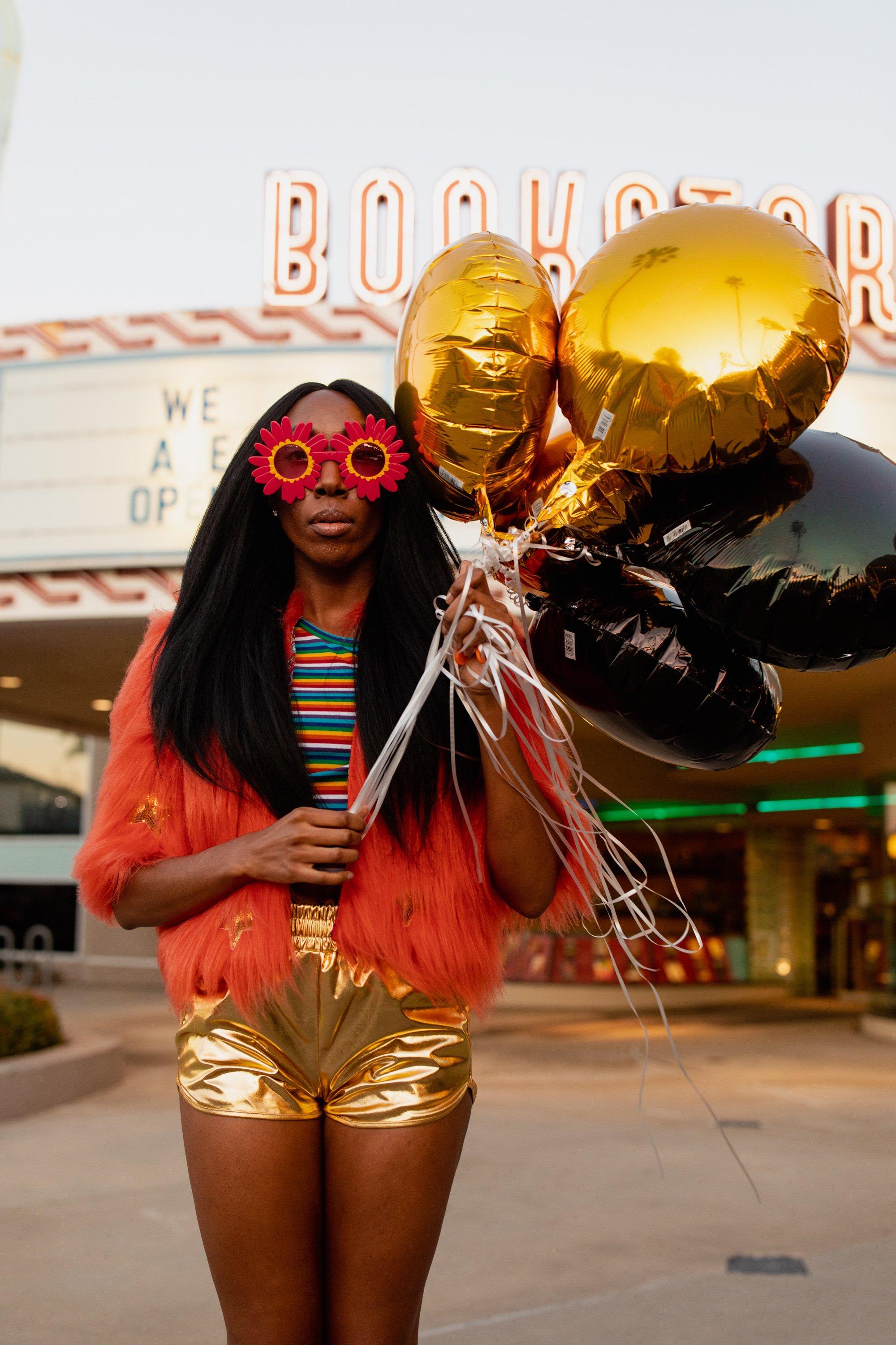 Jennafer Grace Planet Queen orange faux fur jacket on a girl, showcasing the plush, vibrant fur with a stylish fit.