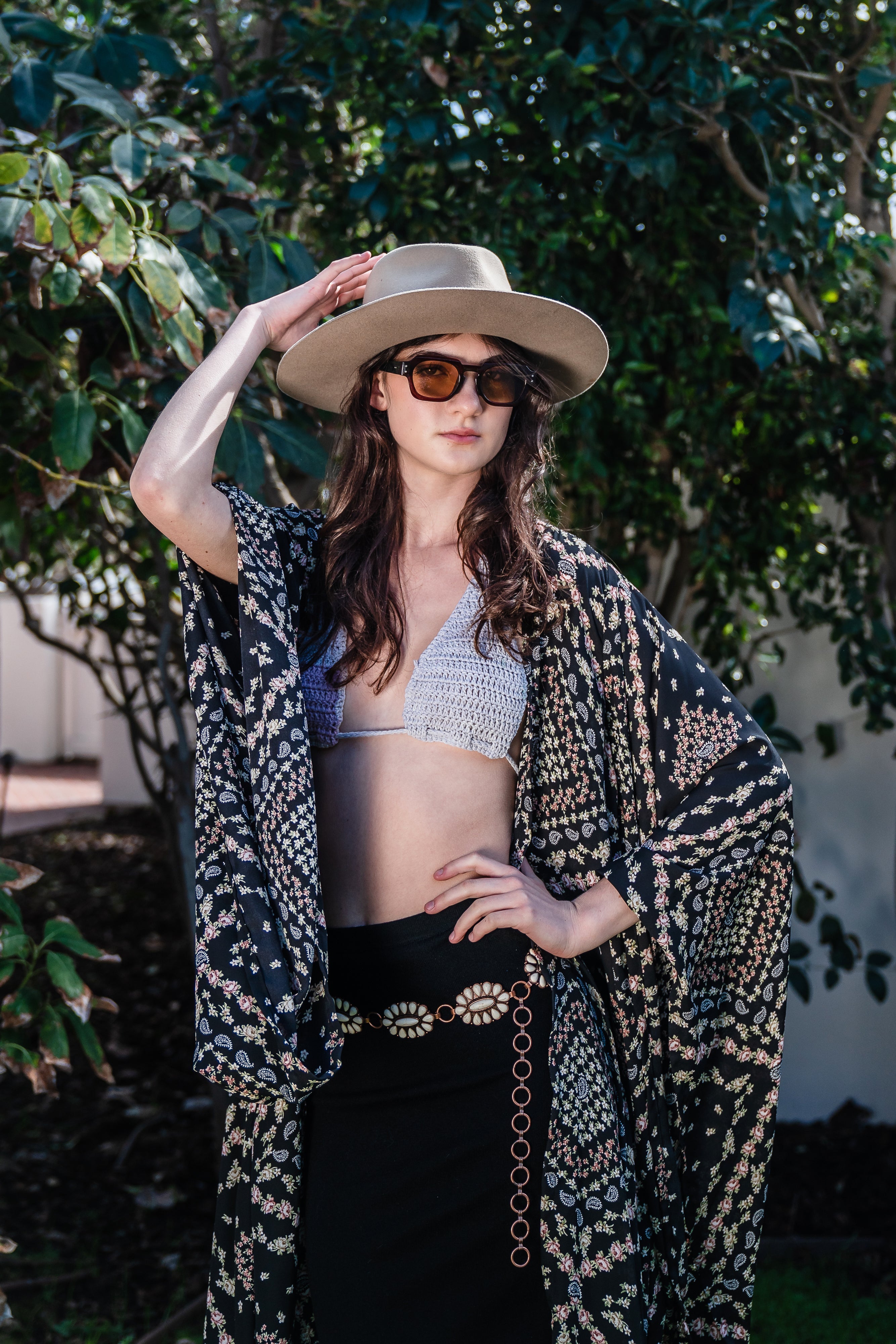 Handmade Antoinette Kimono by Jennafer Grace featuring intricate crochet details and flowing fabric, displayed on a hanger.