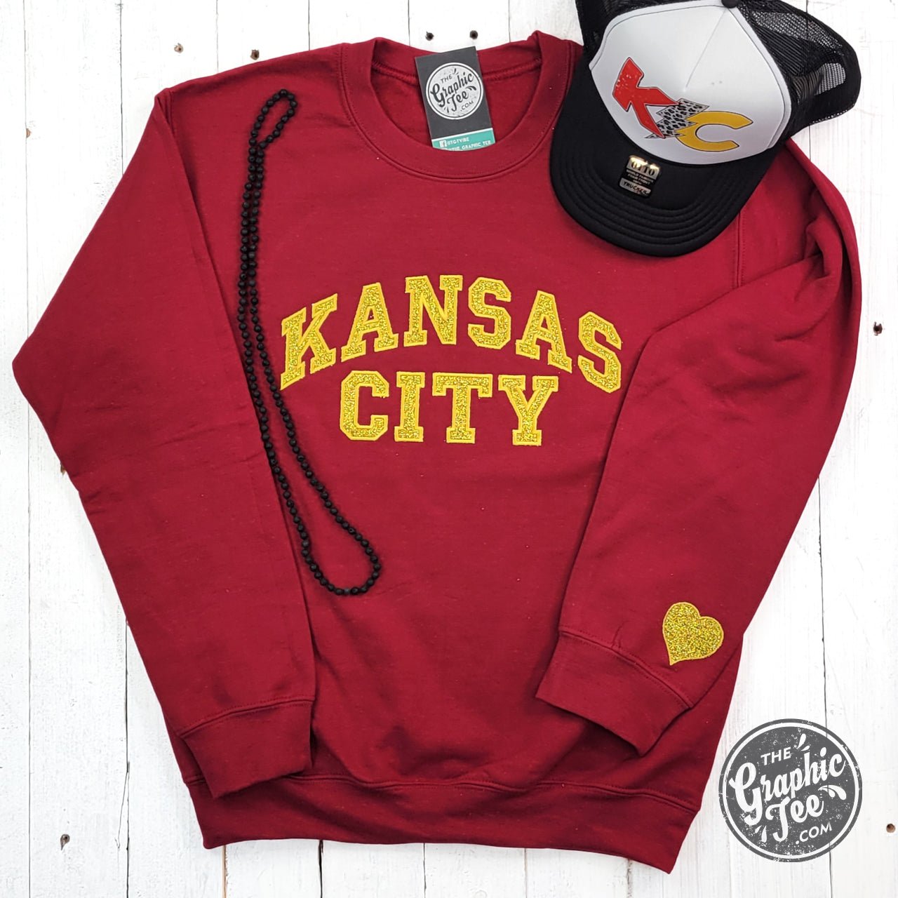 Dark red Kansas City gold glitter applique crewneck sweatshirt by The Graphic Tee, featuring a stylish Kansas City graphic design.