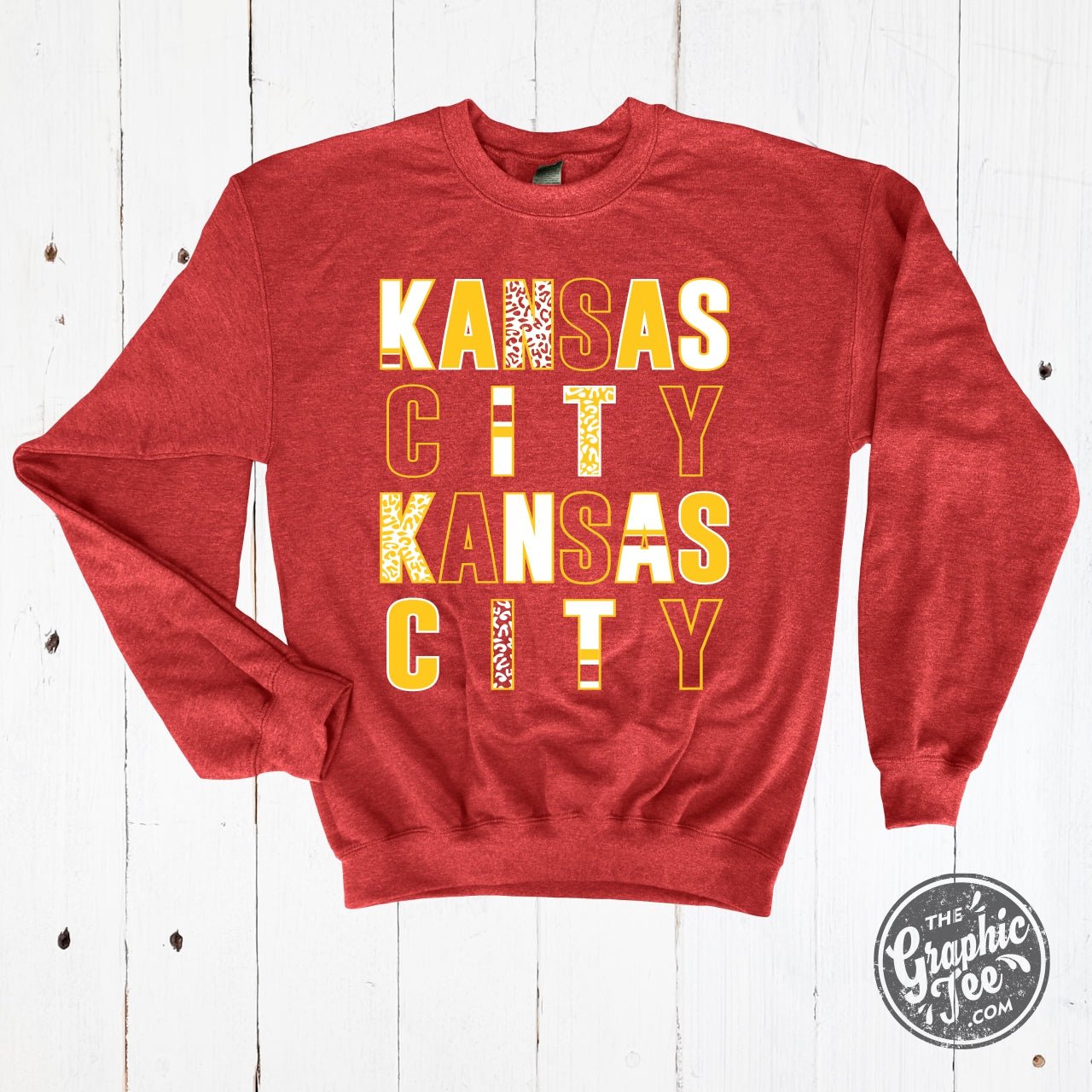 Kansas City multi-pattern letters heather sport scarlet crewneck sweatshirt by The Graphic Tee, front view showing vibrant graphic design.