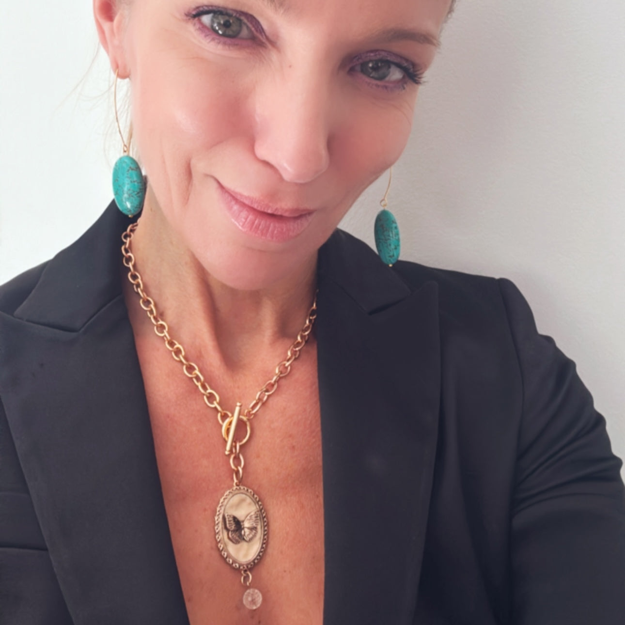 Katia Designs butterfly choker necklace in antique gold with the phrase "She Believed She Could" etched on the pendant.