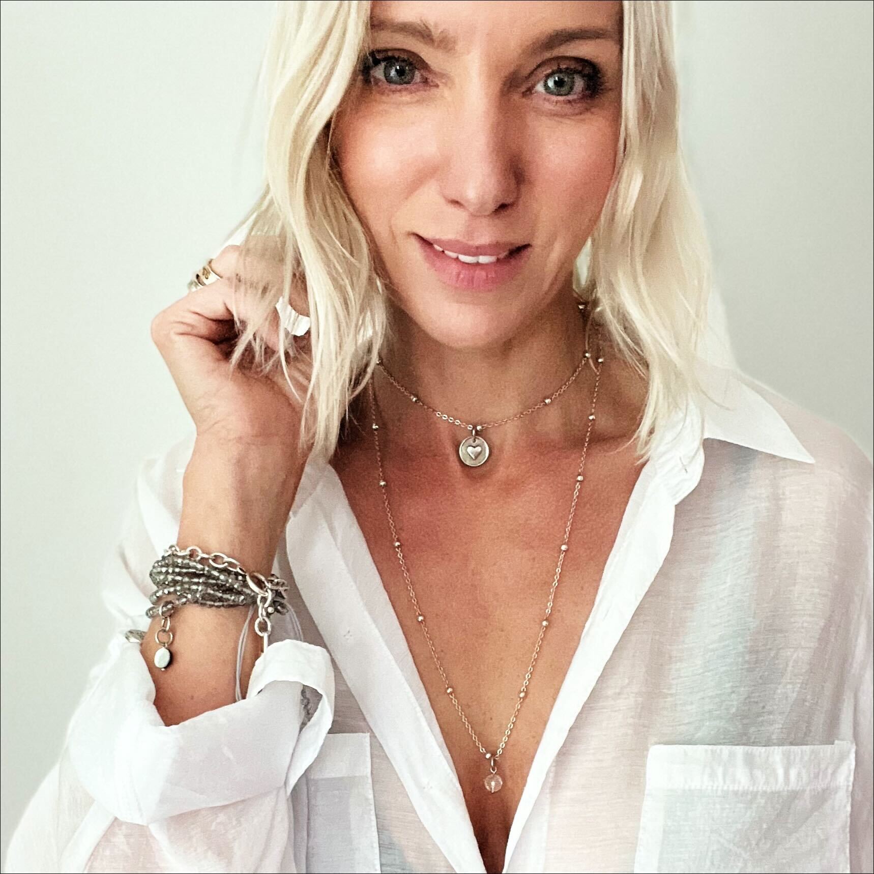 Dainty antique gold necklace by Katia Designs featuring a black lip pearl and "I Am Enough" heart pendant.