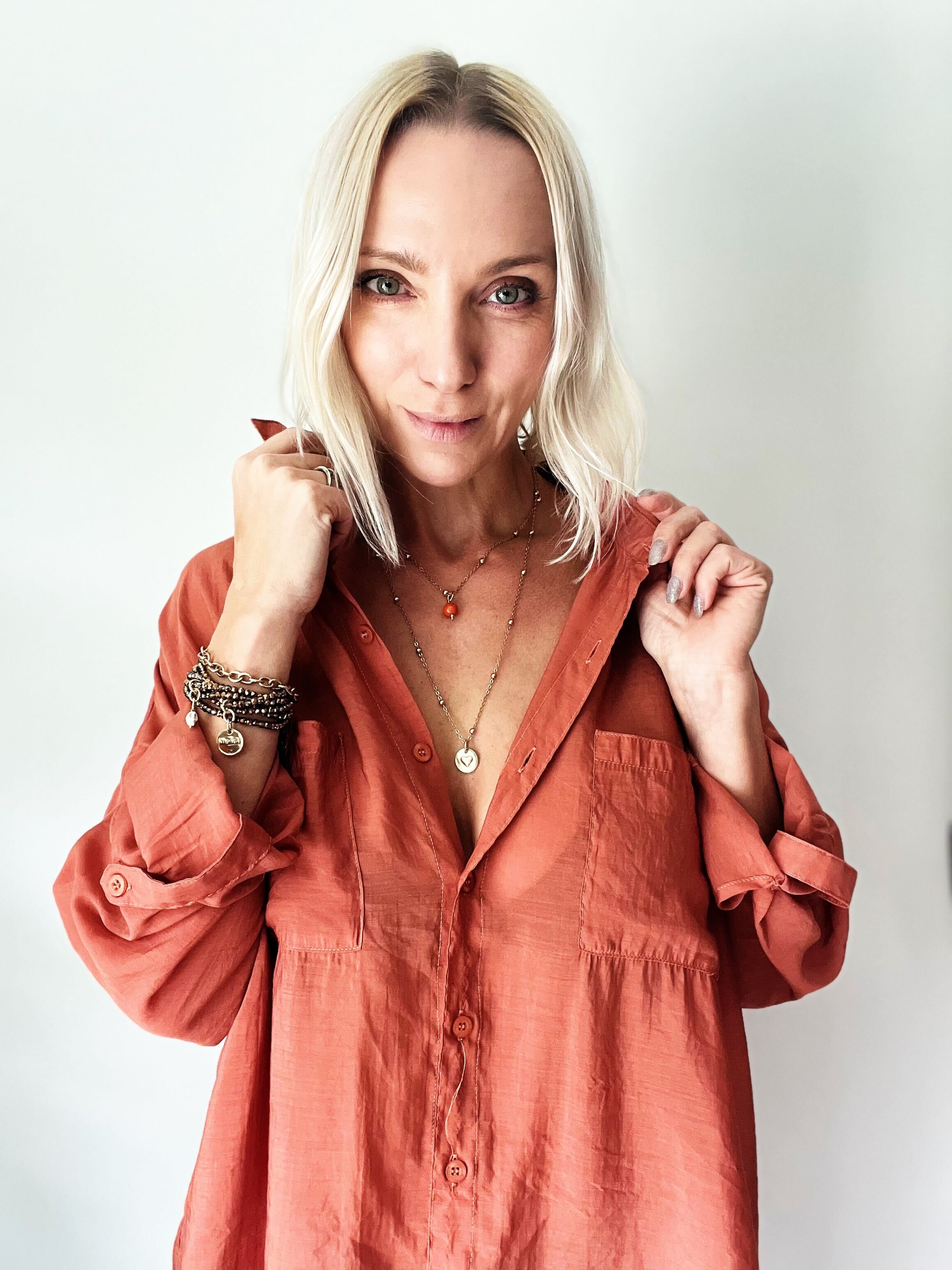 Dainty antique gold necklace by Katia Designs featuring a black lip pearl and a heart pendant with "I Am Enough" inscription.