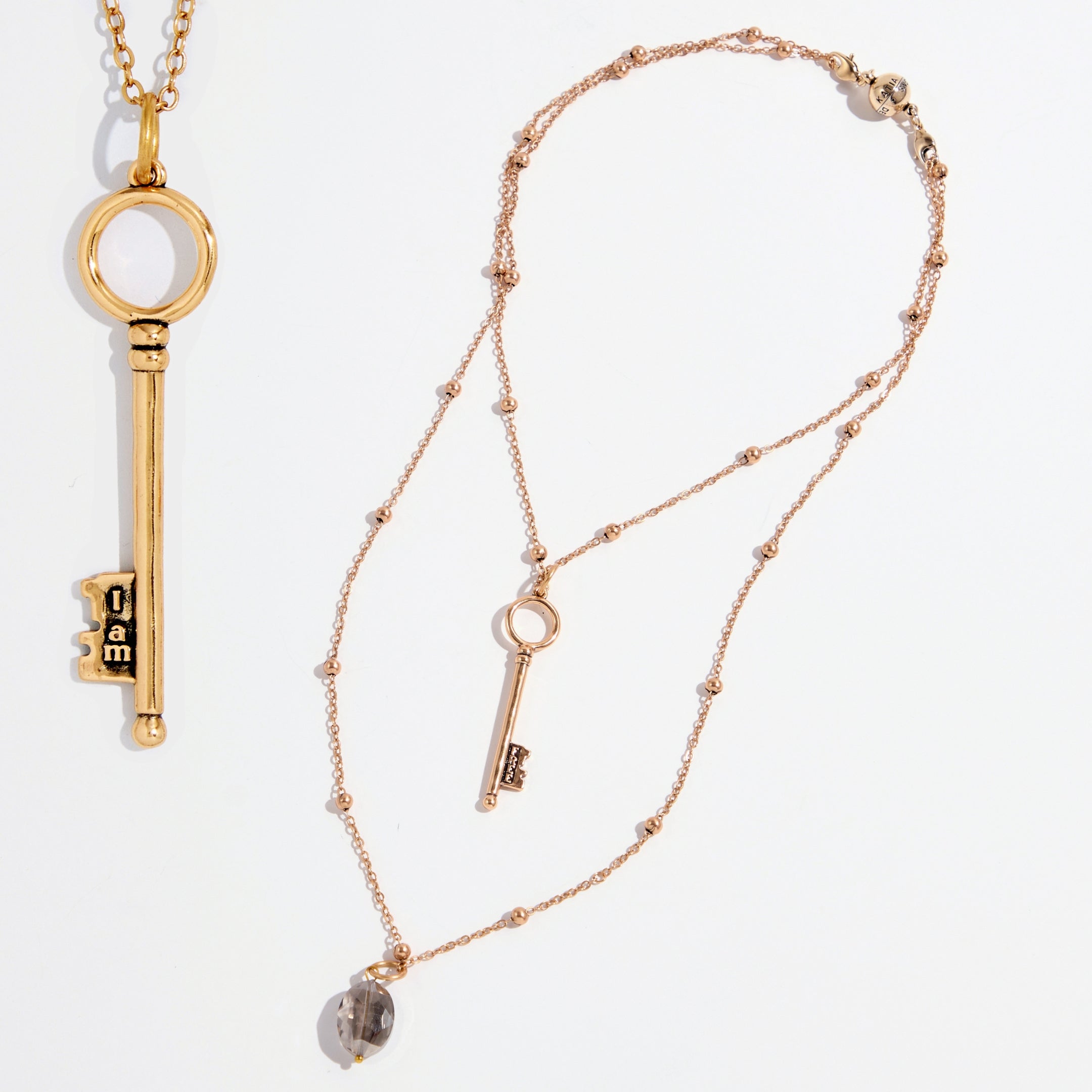 Dainty antique gold "I Am Free" key necklace by Katia Designs, featuring a delicate pendant on a fine chain.