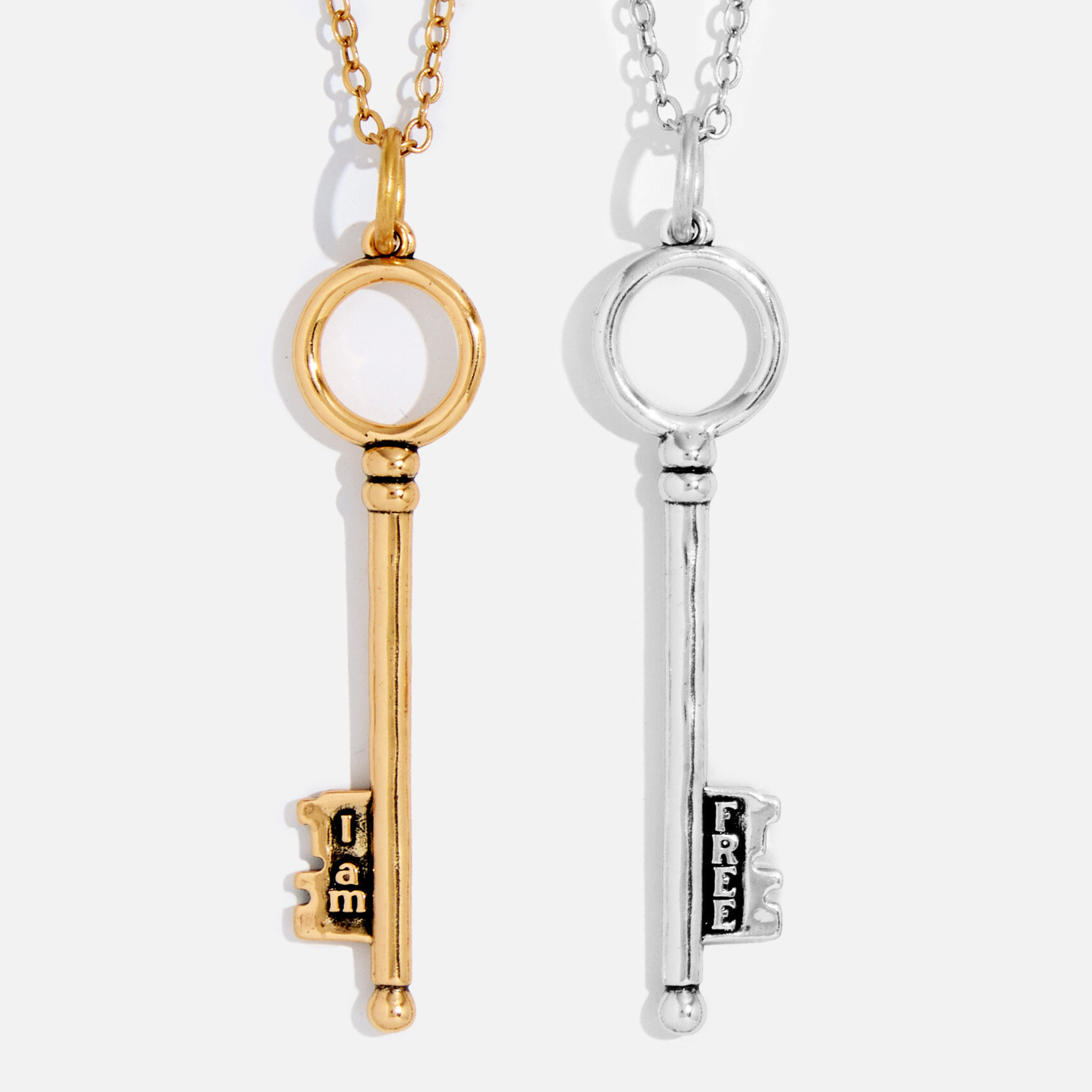 Dainty antique gold "I Am Free" key necklace by Katia Designs, featuring a delicate chain and key pendant.