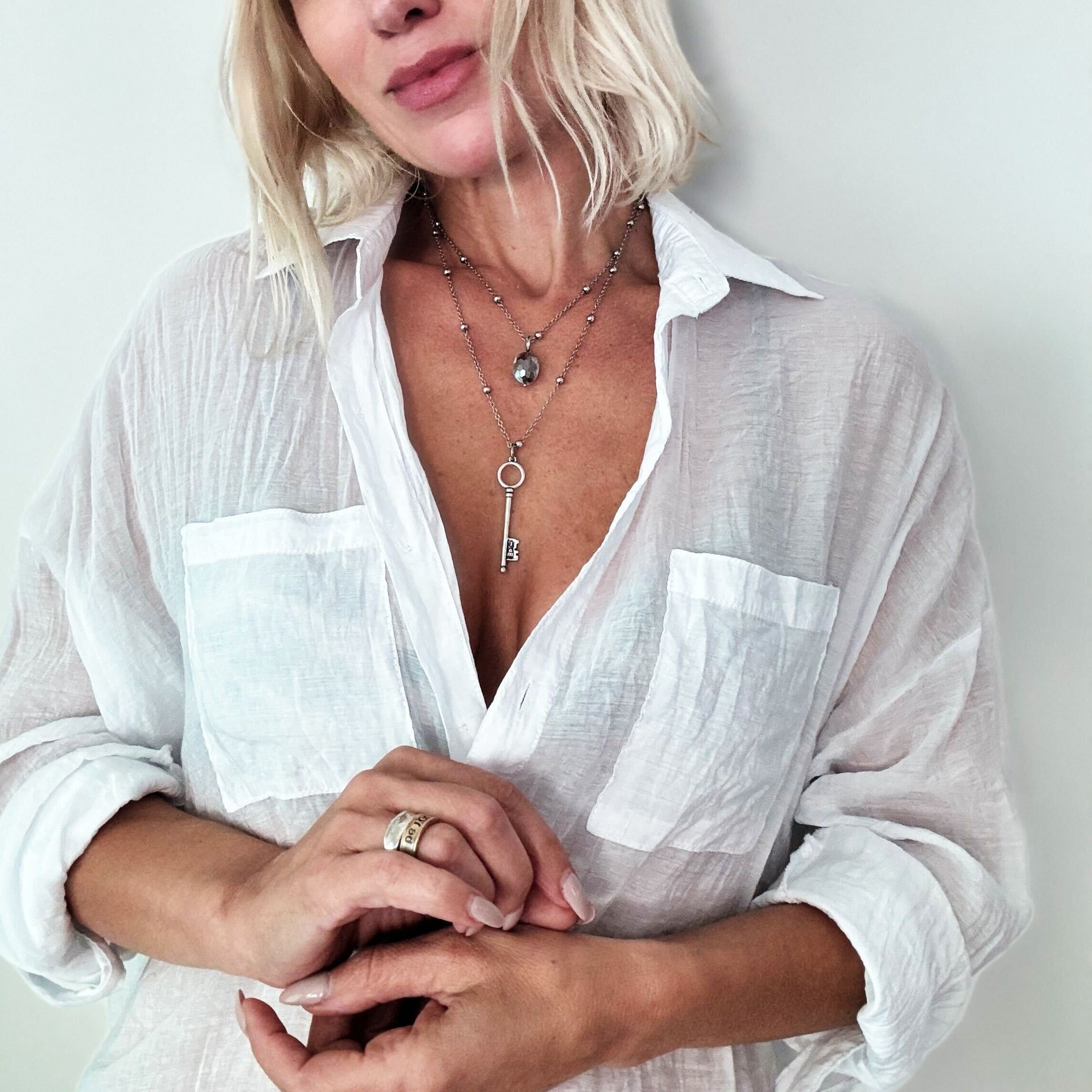 Dainty antique gold I Am Free key necklace by Katia Designs featuring a delicate pendant on a fine chain.