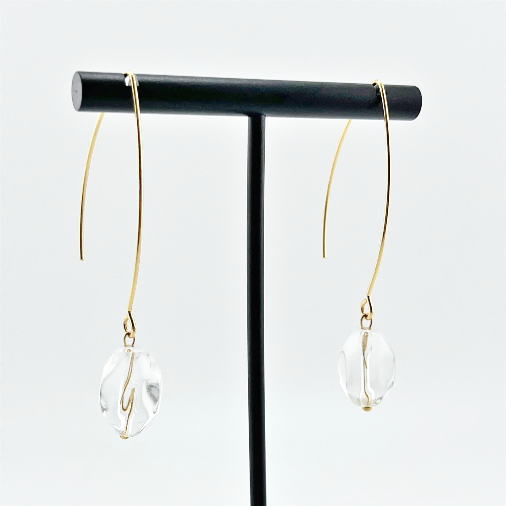 Katia Designs small stone drop earrings with antique gold finish and clear crystal quartz accents, elegant jewelry for women.