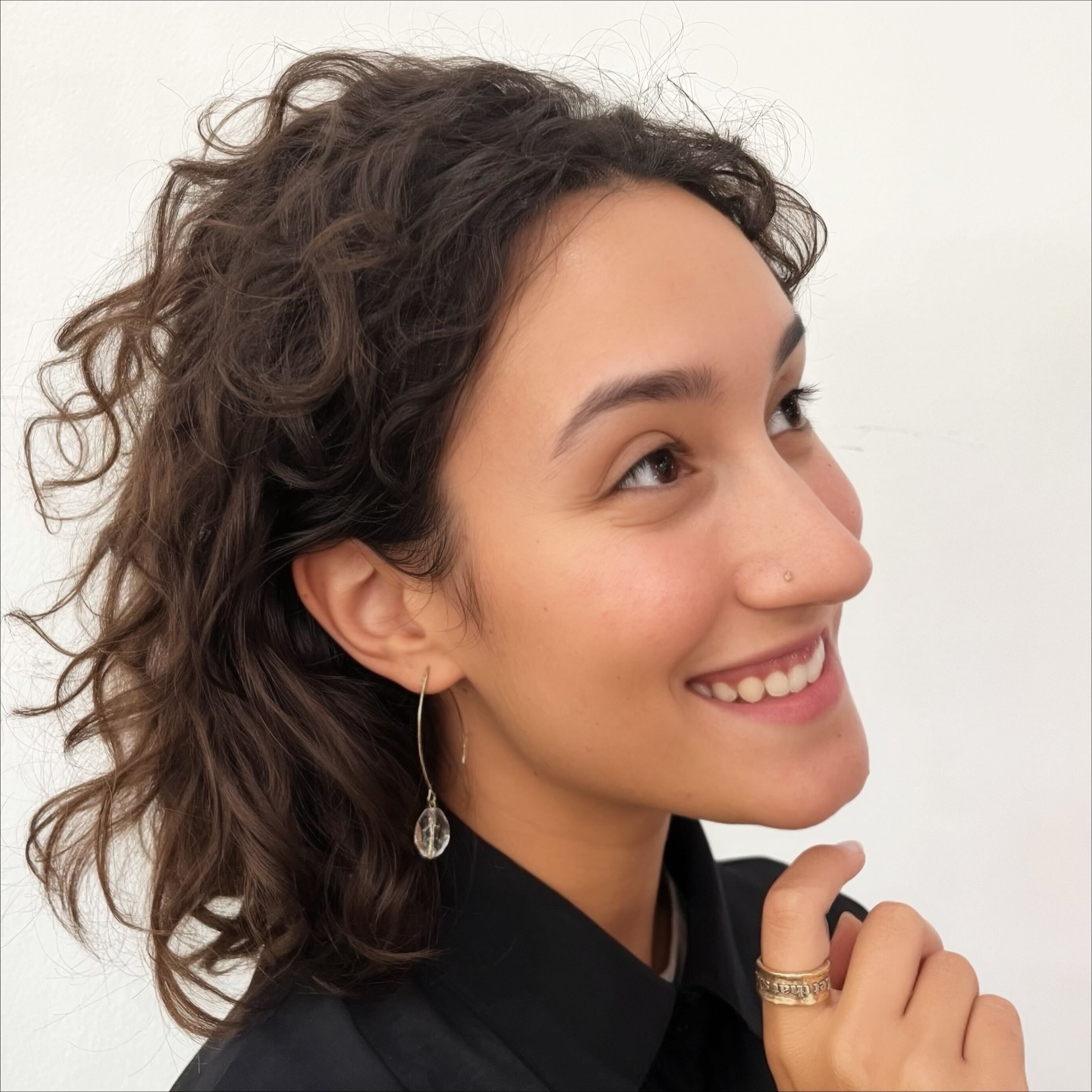 Katia Designs small stone drop earrings with antique gold finish and clear crystal quartz accents, elegant jewelry accessory.